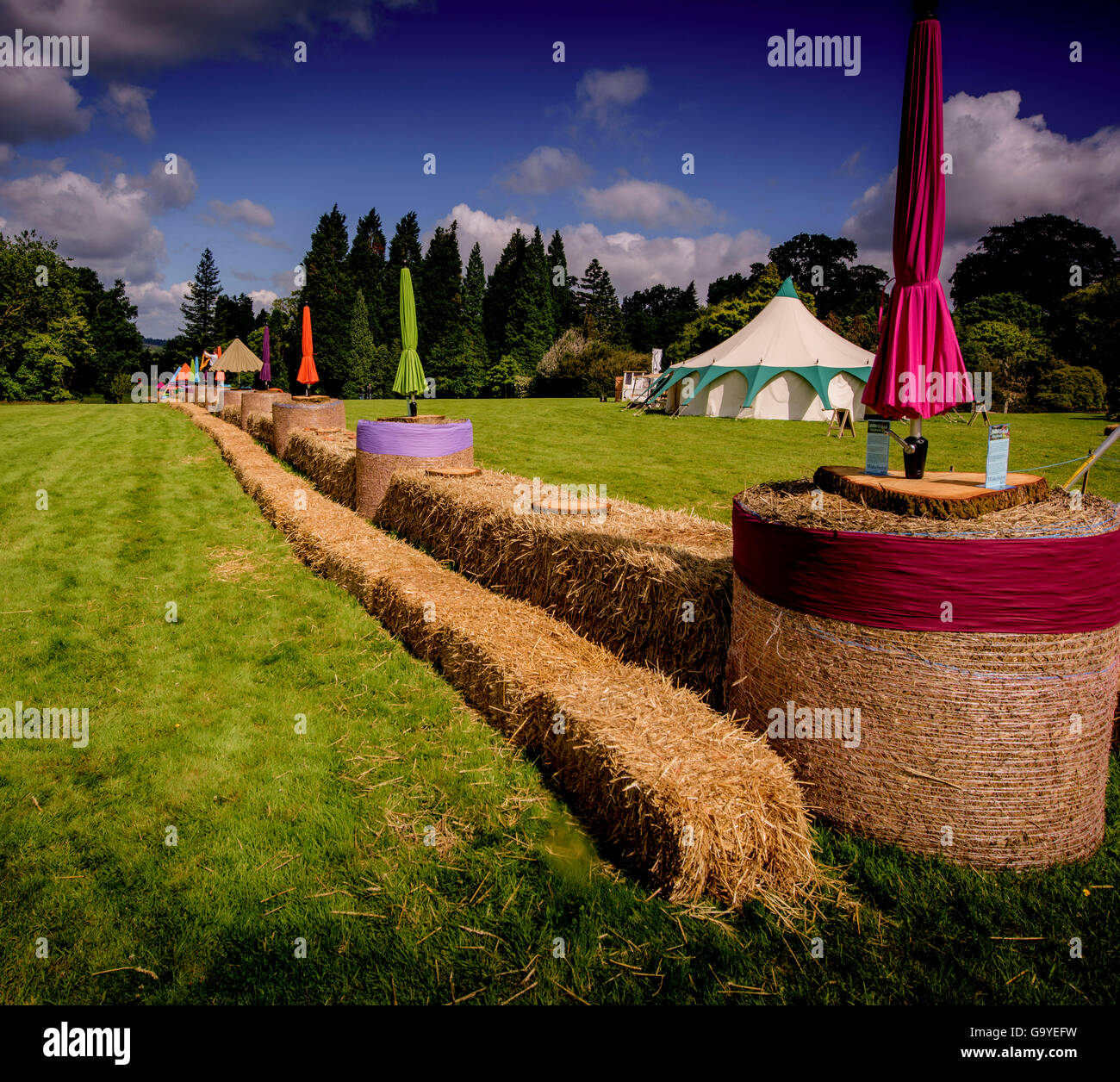 Wakehurst, West Sussex, UK. 2nd July, 2016. Preparations underway for visitors to Wakehurst's Wild Food Festival take part in a Guinness World Records™ attempt for the longest straw-bale picnic table. Iain Parkinson and George Morris put the final hay bales in place. Credit:  Jim Holden/Alamy Live News Stock Photo
