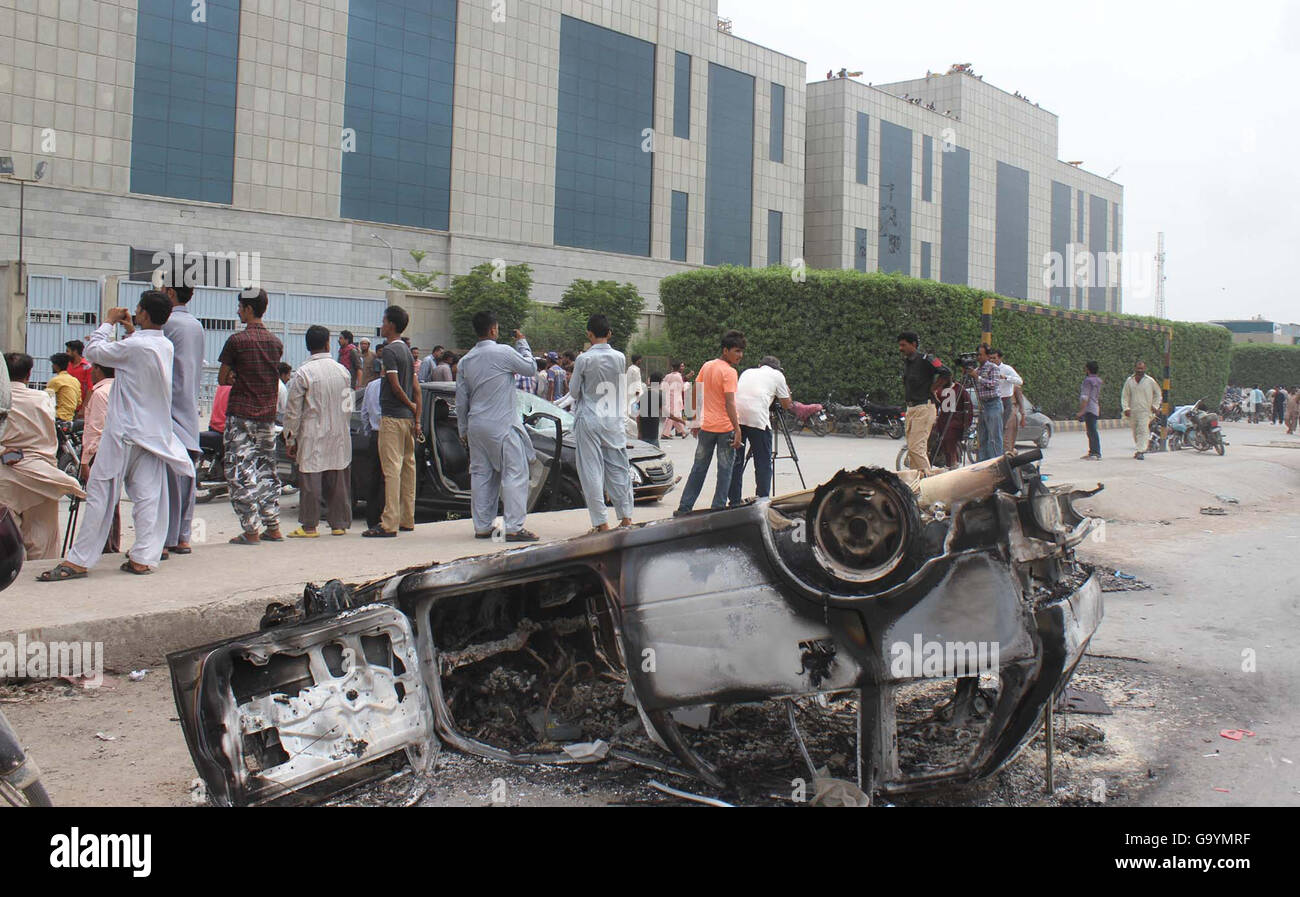 Laborers of denim mills smashed cars during demonstration against nonpayment of bonus and salaries on time before arrival of Eid-ul-Fitar, at Vita Chowrangi in Korangi area of Karachi July 04, 2016. Stock Photo