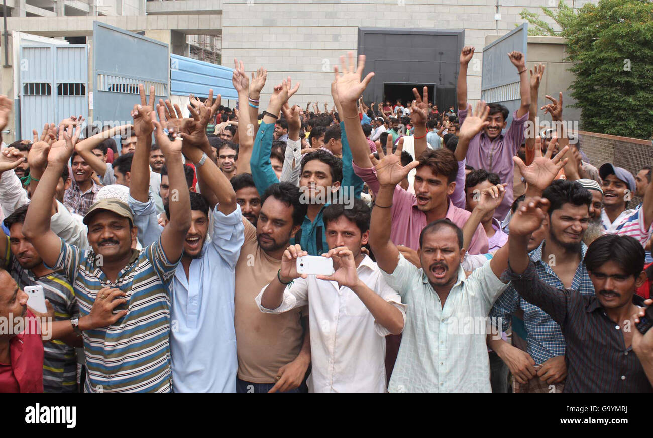 Laborers of denim mills are chanting slogans against nonpayment of bonus and salaries on time before arrival of Eid-ul-Fitar, at Vita Chowrangi in Korangi area of Karachi July 04,2016. Stock Photo