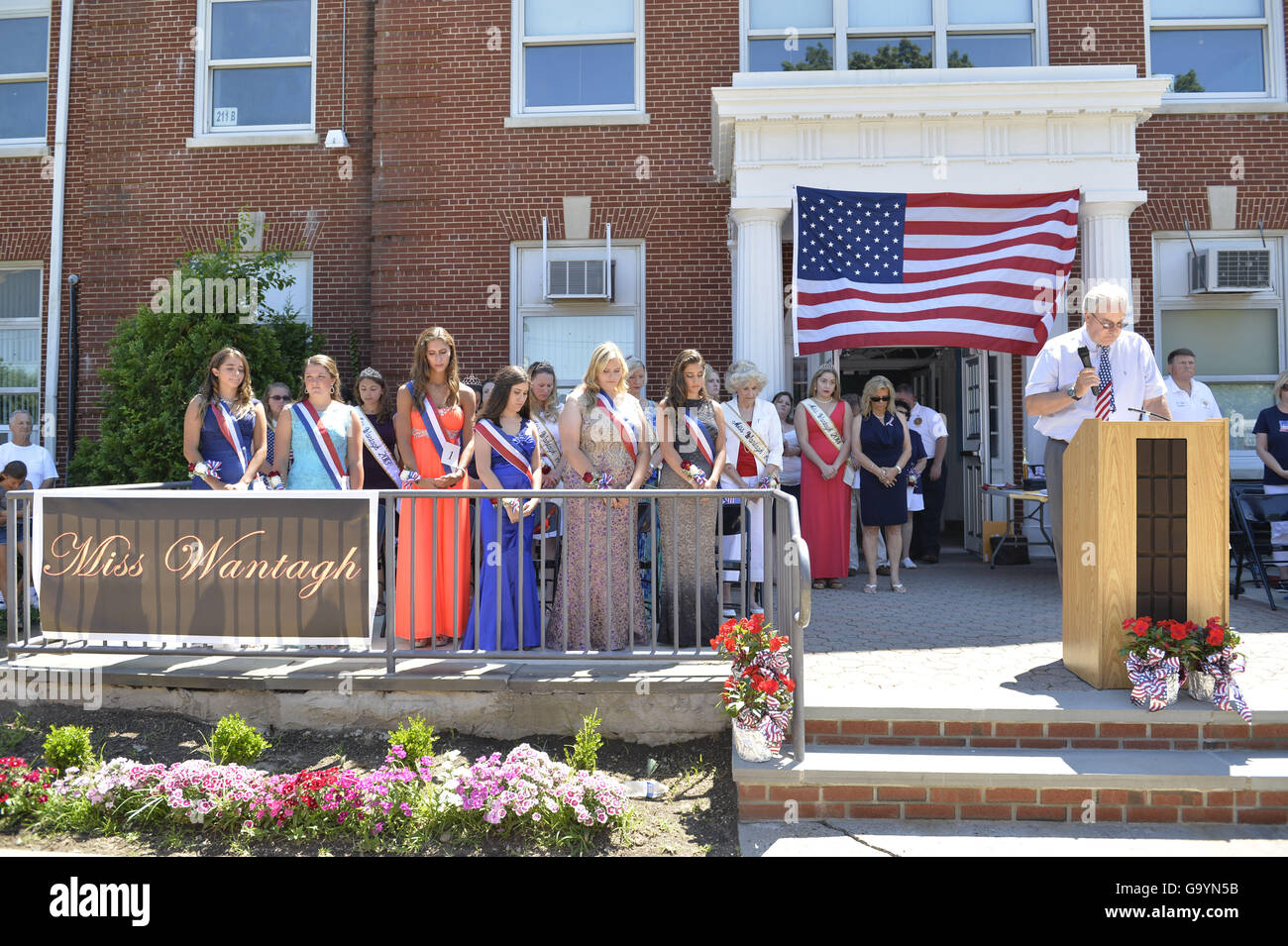 Wantagh, New York, USA. 4th July, 2016. Miss Wantagh contestants, past and present, bow their heads and pause for moment of silence in honor of American military members at start at the 60th Annual Miss Wantagh Pageant crowning ceremony, an Independence Day tradition on Long Island. Since 1956, the Miss Wantagh Pageant, which is not a beauty pageant, crowns an area high school student based mainly on academic excellence and community service. © Ann Parry/ZUMA Wire/Alamy Live News Stock Photo