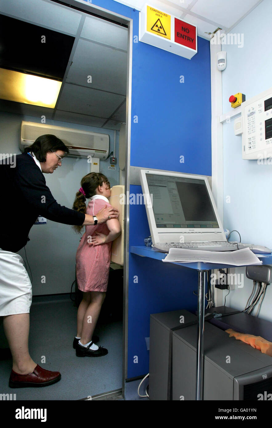 A pupil from Southfield Junior School in Luton, Bedfordshire, prepares for a chest X-ray after several pupils from the same class tested positive for TB. Stock Photo