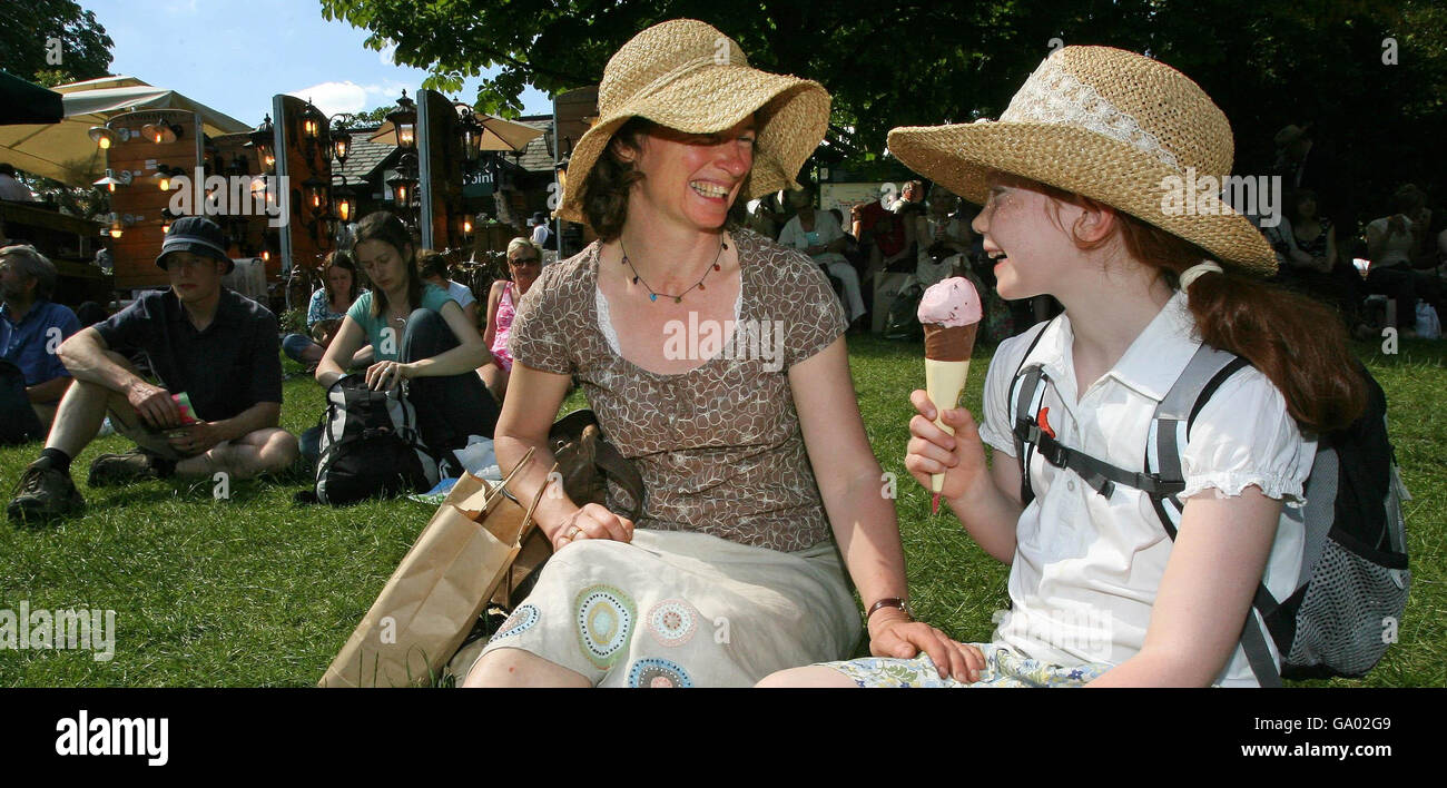 Seven-year-old Beatrice Hill enjoys an ice cream with her mother Rachel in the hot weather at the Chelsea Flower Show, in the grounds of the Royal Chelsea Hospital, west London. Stock Photo