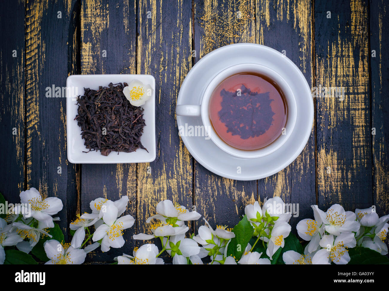 Tea cup and dry tea on wooden vintage table, top view Stock Photo - Alamy