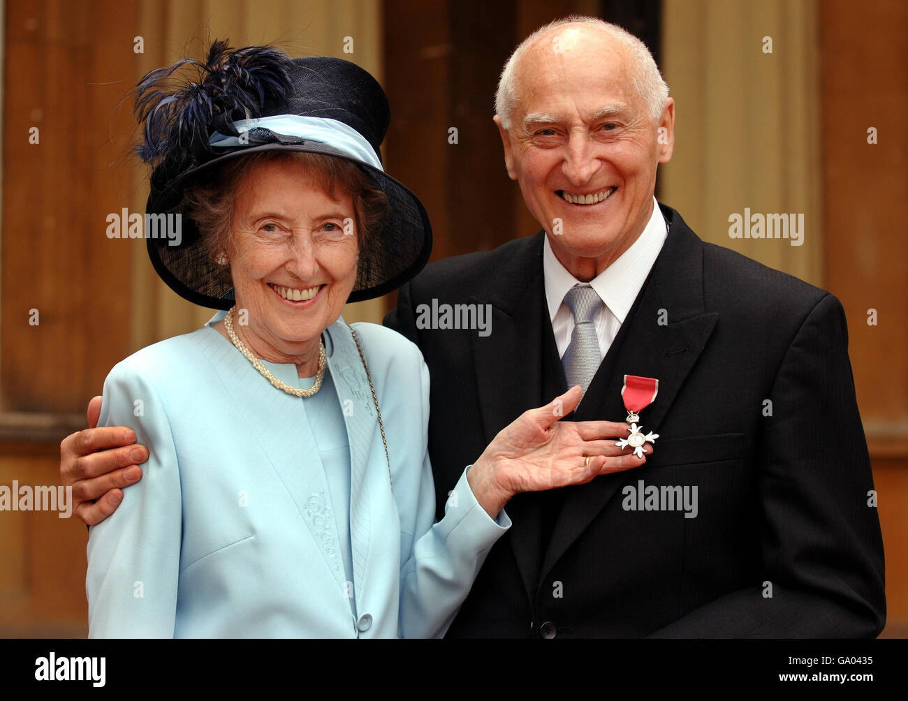 John Barrett, former 'voice of Wimbledon', with wife Angela Mortimer, the  1961 Wimbledon tennis ladies singles champion, after he collected his MBE  from the Prince of Wales at an Investiture ceremony at