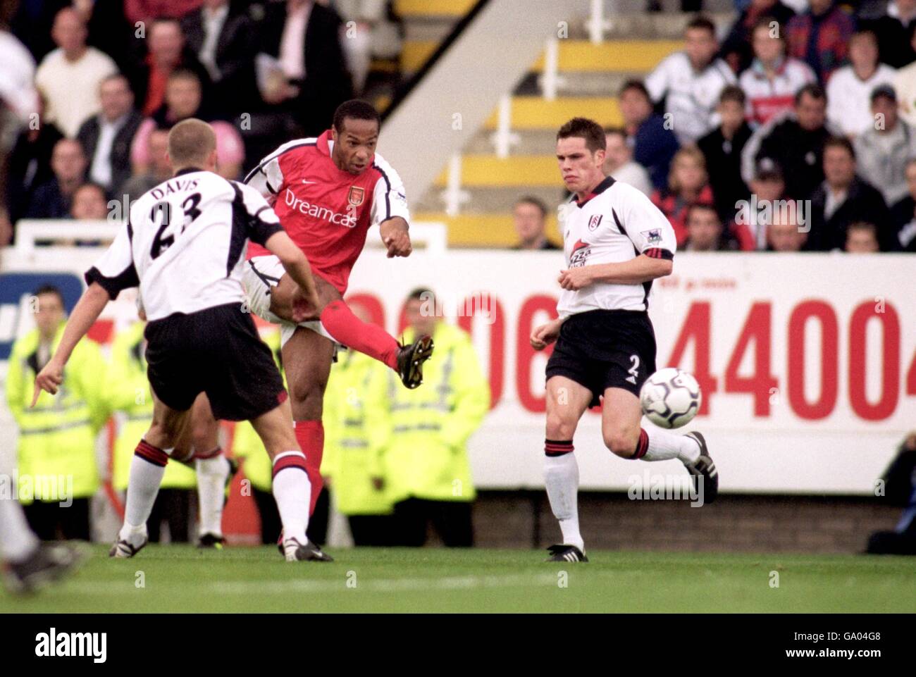 Arsenal's Thierry Henry gets a shot in despite the close attention from ...