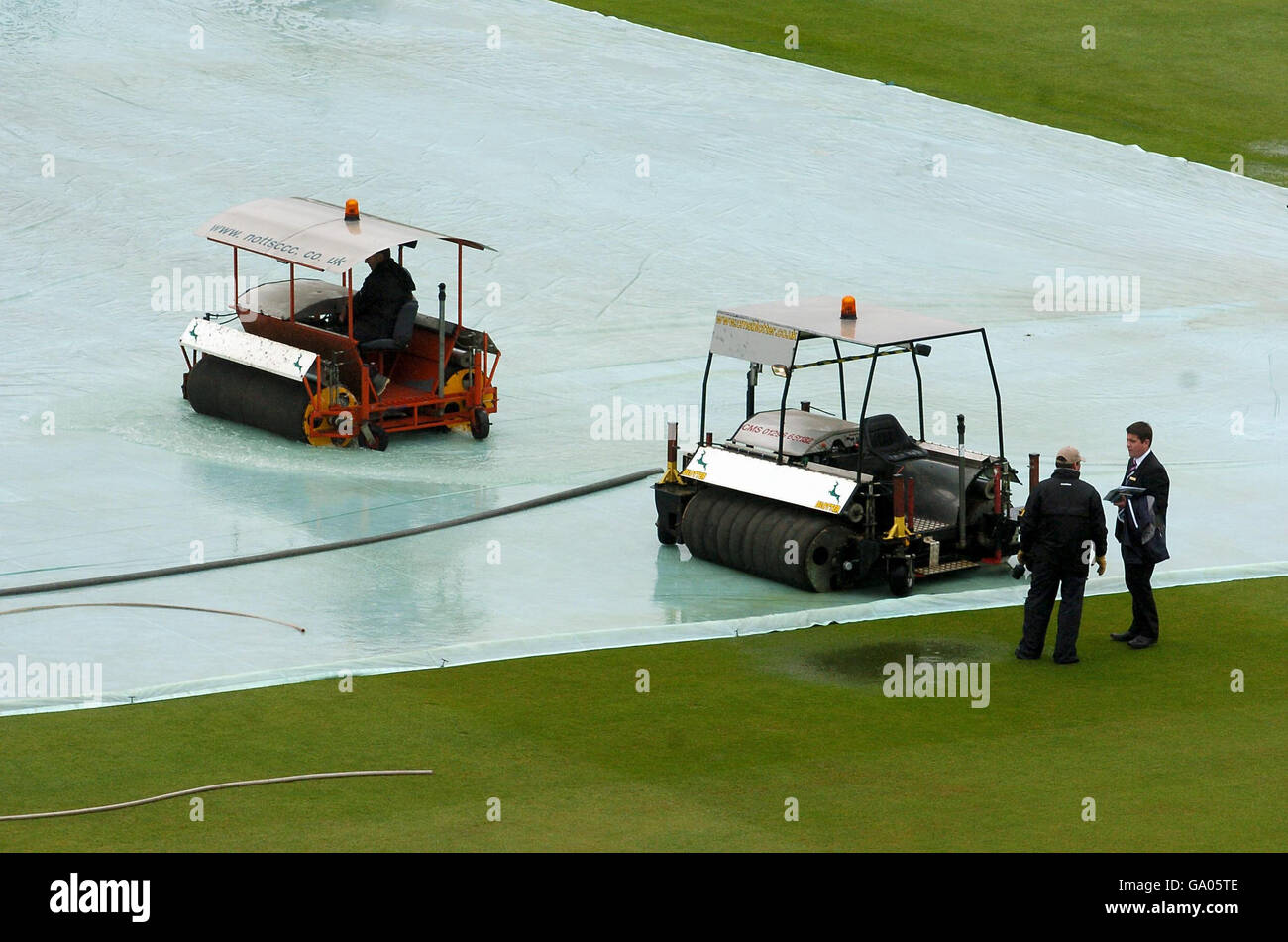 Groundstaff attempt to clear water from the pitch as rain delays play in The Friends Provident match between Nottinghamshire and Derbyshire at Trent Bridge, Nottingham. Stock Photo