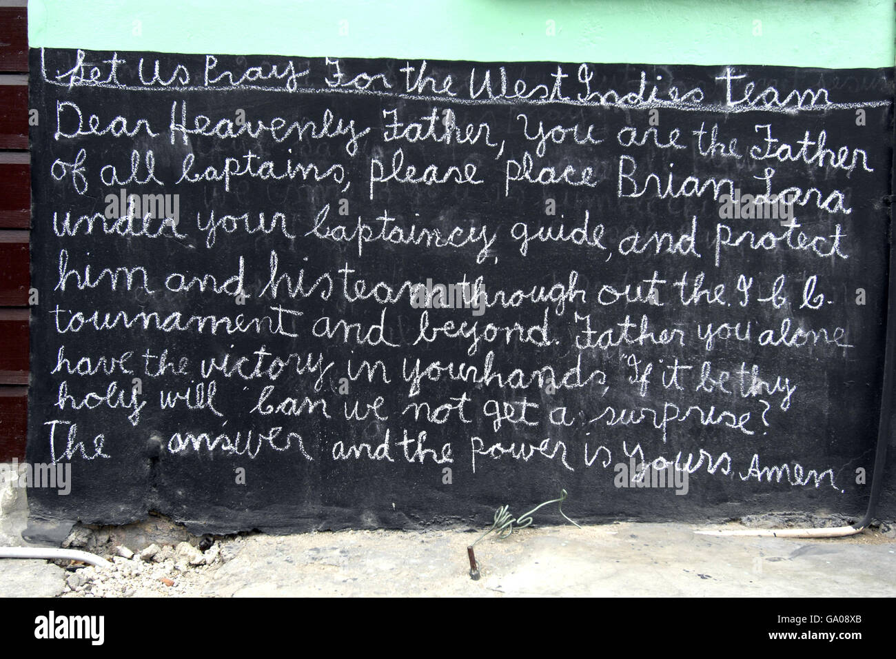A message of support for the West Indies cricket team written on the side of a house Stock Photo