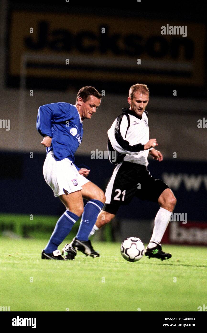 Ipswich Town's Jim Magilton (l) passes the ball under pressure from Torpedo Moscow's Vyacheslav Kamoltsev (r) Stock Photo