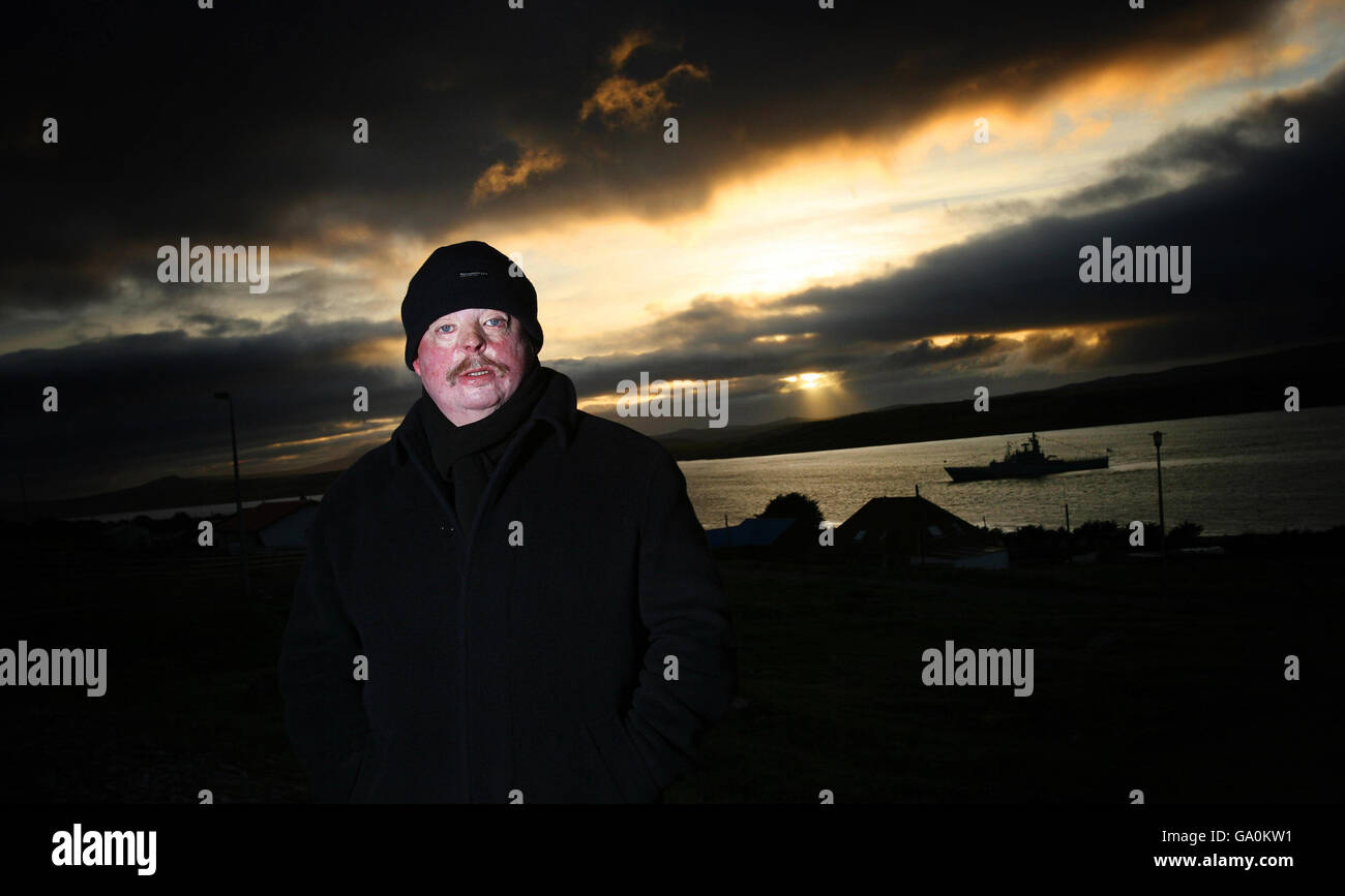 Simon Weston in Stanley in the Falkland Islands on the evening of 'liberation day' with HMS Dumbarton Castle sailing past, one of only two ships from the Falklands Task Force that's still in service. Stock Photo