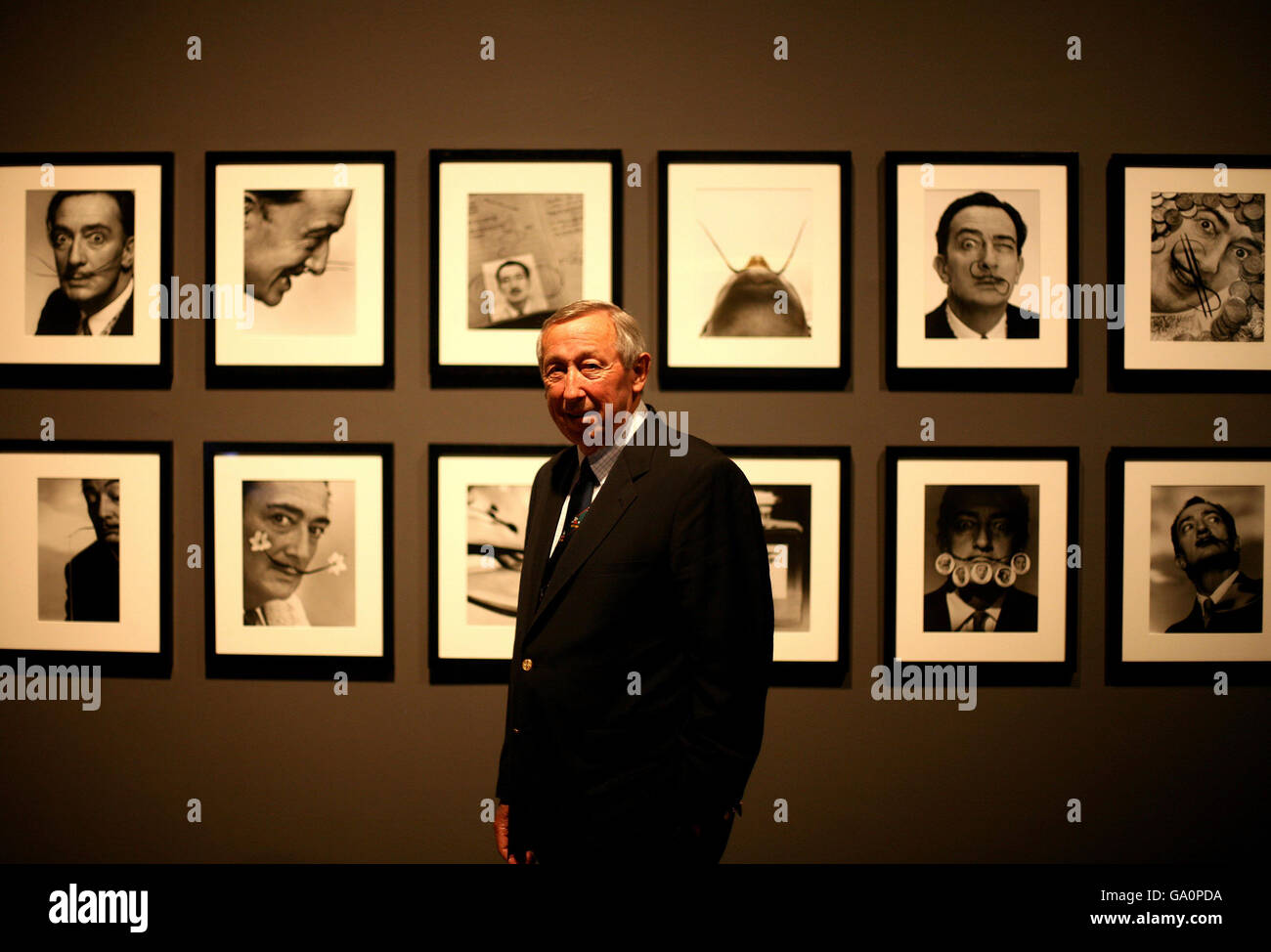 Roy Disney poses in front of Salvador Dali's, 'Dali's Mustache: A photographic interview 1954' at the new Dali & Film exhibition which opens on June 1st at the Tate Modern, central London. Stock Photo