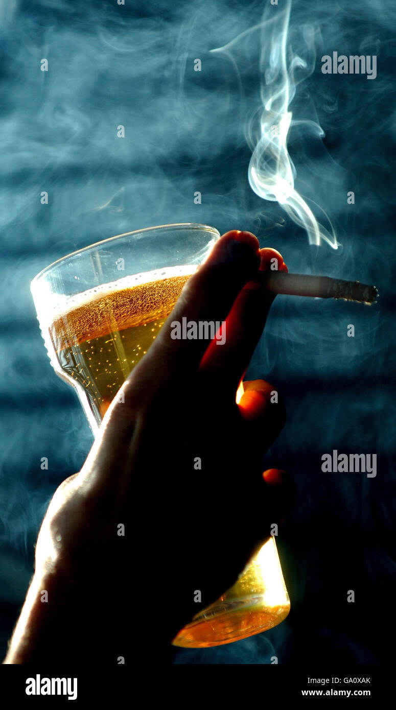 A cigarette is smoked in a pub, just weeks ahead of Britain's smoking ban  Stock Photo