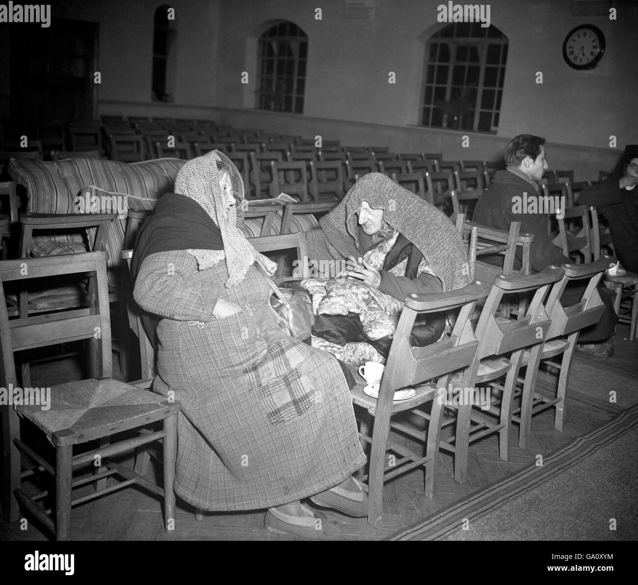 A blind elderly man in Benfleet Methodist Church with another survivor on Canvey Island. The Thames Estuary holiday resort was under many feet of water and evacuation of the 13,000 population was under way as floods swept the east coast of Britain and claimed the lives of at least 59 people. Stock Photo