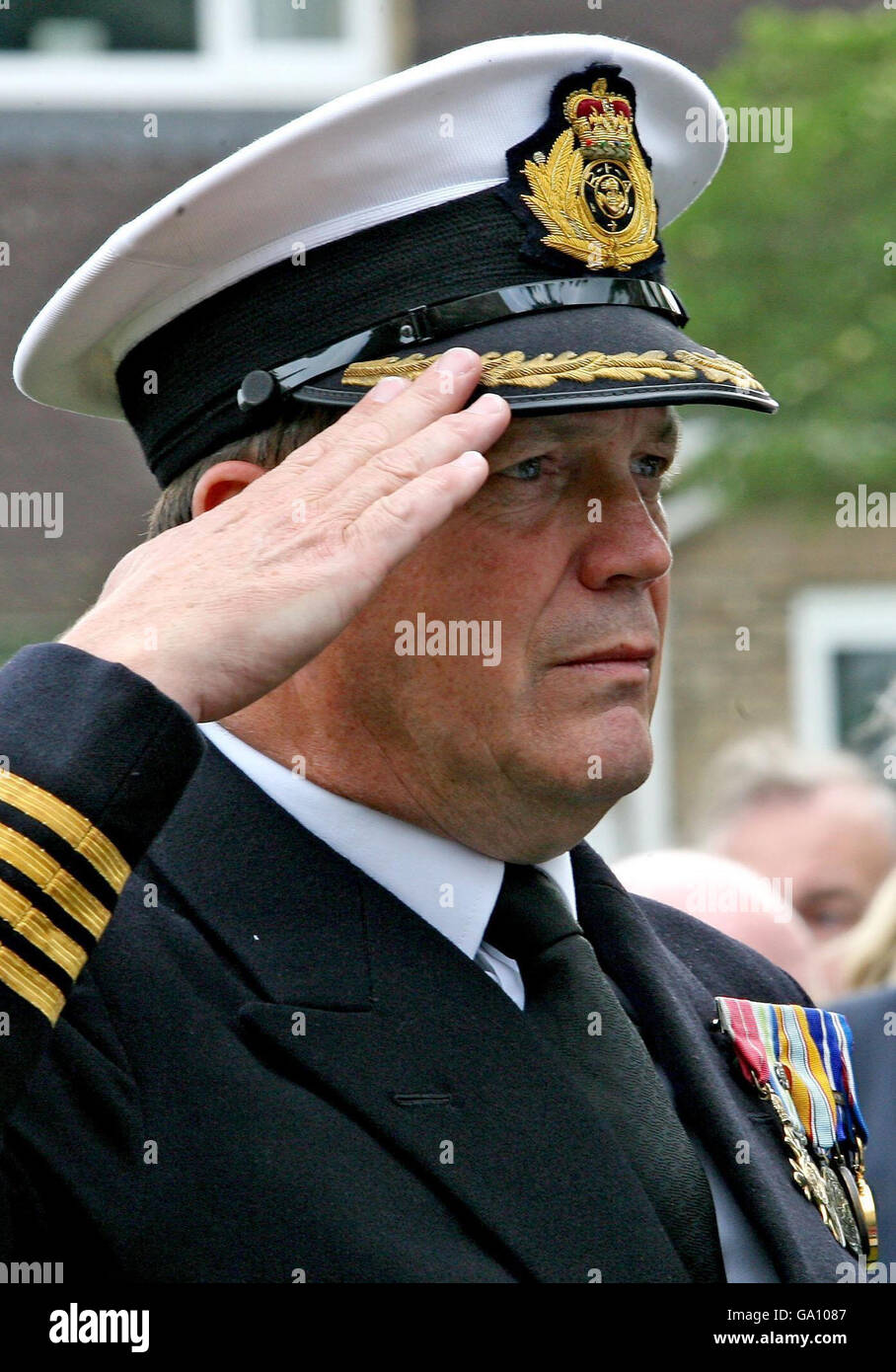 Captain Robin Green salutes during a Falklands Sir Galahad memorial