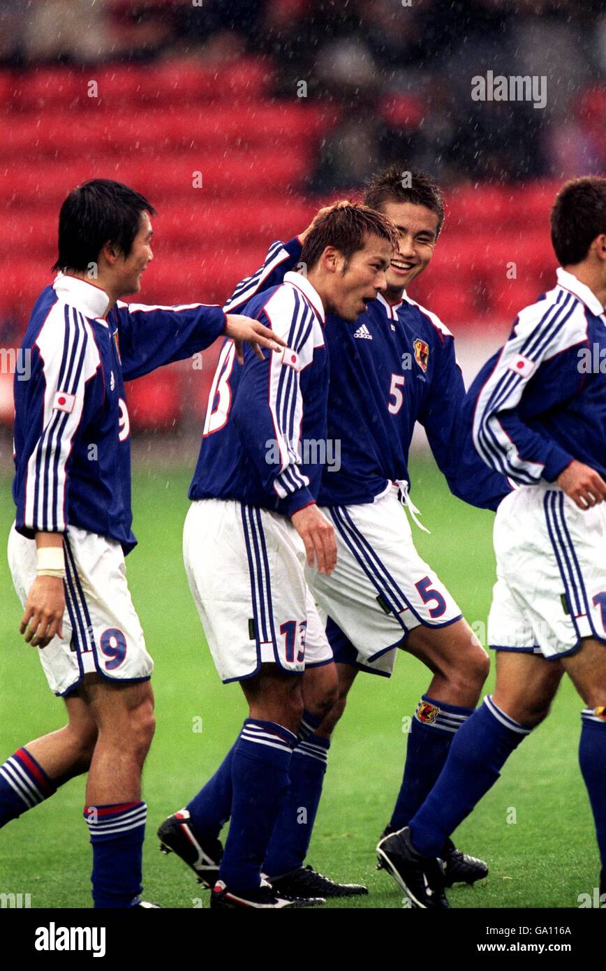 Soccer - Friendly - Japan v Nigeria. Japan's Atsushi Yanagisawa is congratulated by his team mates after scoring the first goal in the rain against Nigeria Stock Photo