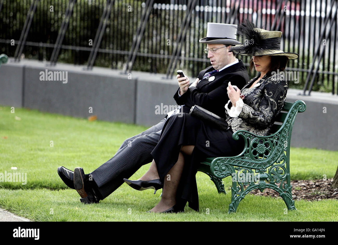 Race goers use their mobiles at the Ascot Racecourse, Berkshire on day two of Royal Ascot. Stock Photo