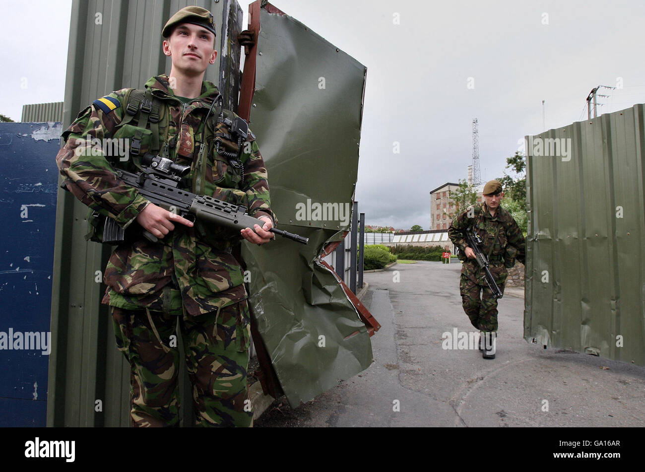 Lt James Phipps (left) with Private Andrew Mason of the Princess of Wales's Royal Regiment close the gates at the Bessbrook Mill military complex, south Armagh as soldiers will pull out of the area today. Stock Photo
