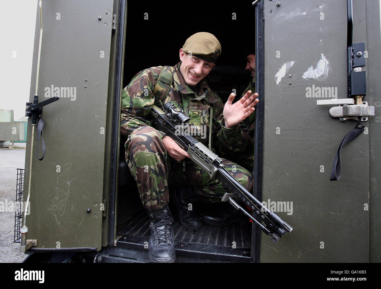 Private Andrew Mason, of the 2nd Battalion Princess of Wales's Royal Regiment, waves from the back of a departing Army landrover at the Bessbrook Mill military complex, south Armagh as soldiers will pull out of the area today. Stock Photo