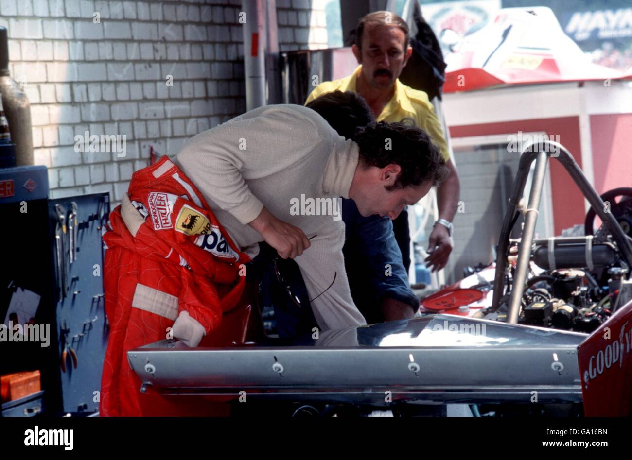 Niki Lauda checks his Ferrari 312T2 before the start of the British Grand Prix Stock Photo
