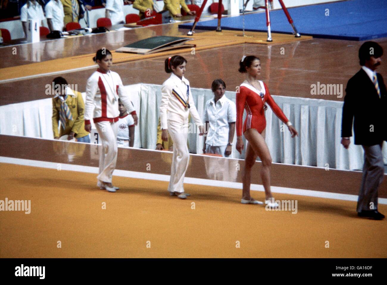 (L-R) The medallists in the women's all-around walk back to the changing rooms after receiving their medals: USSR's Nelli Kim (silver), Romania's Nadia Comaneci (gold) and USSR's Lyudmila Tourischeva (bronze) Stock Photo