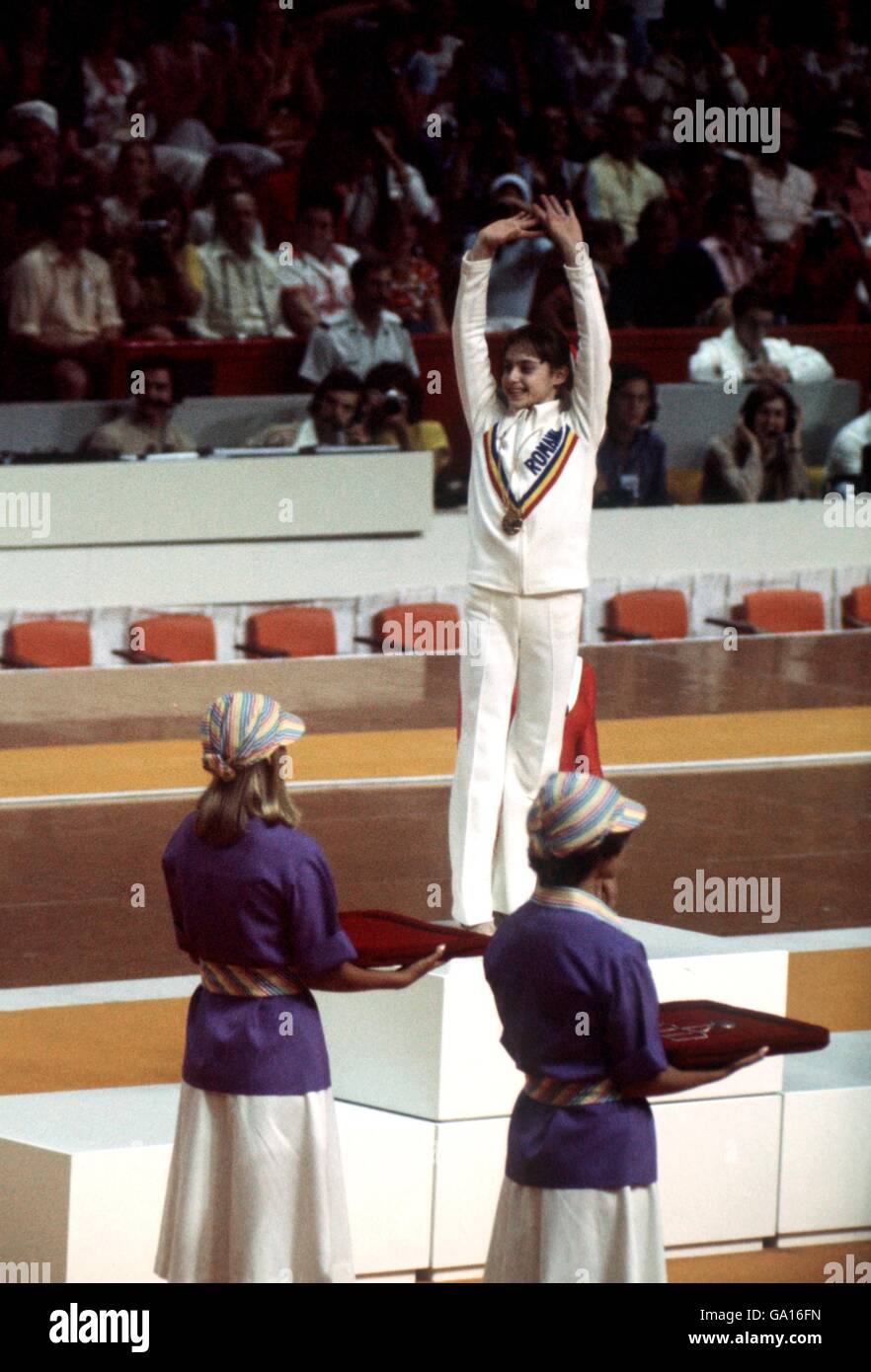 Romania's Nadia Comaneci waves to the crowd as she steps onto the podium to receive her gold medal Stock Photo