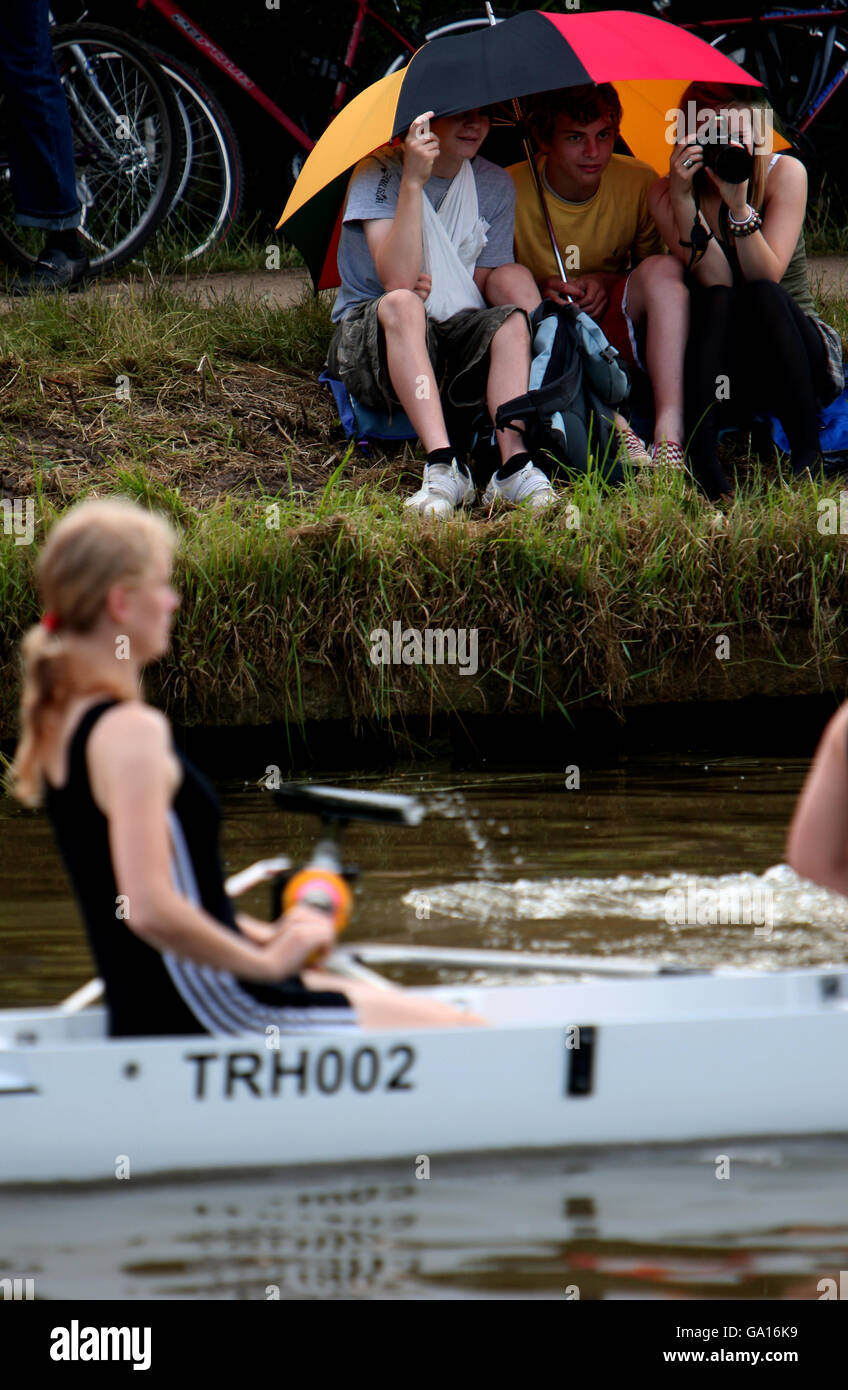 Spectators watch the Cambridge University May Bumps on the River Cam at Fen Ditton, Cambridgeshire. Stock Photo