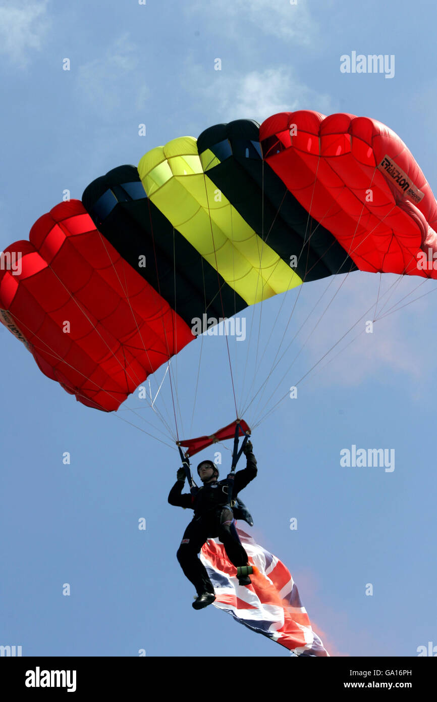 A Parachutist arrives to hand over the keys to a Jeep won during the Style of the Downs competition Stock Photo