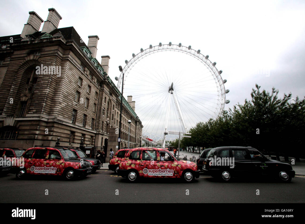 A number of black cabs showing off their new look at the London Eye
