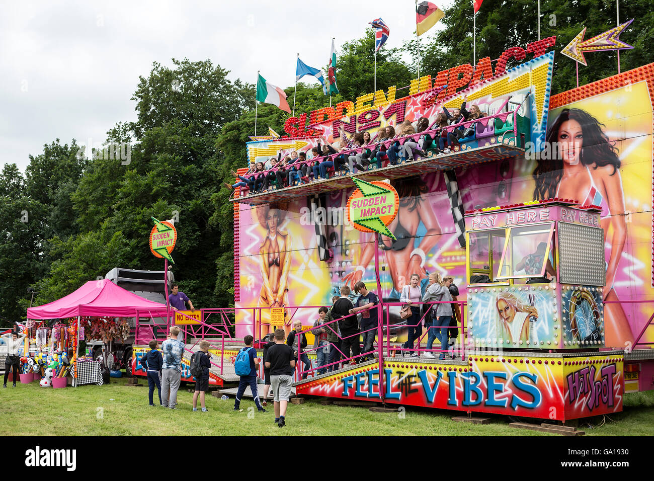 Sudden Impact fairground ride in action with people standing watching Stock Photo