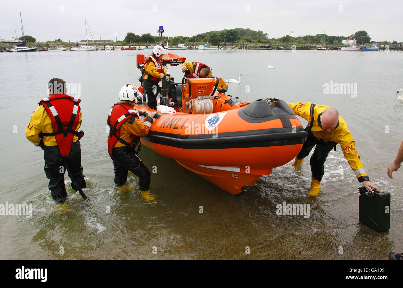 Members of the RNLI return to Littlehampton Lifeboat Station in West Sussex to refuel this morning to enable them to continue their search after a toddler was found floating in the sea off the resort last night. Stock Photo