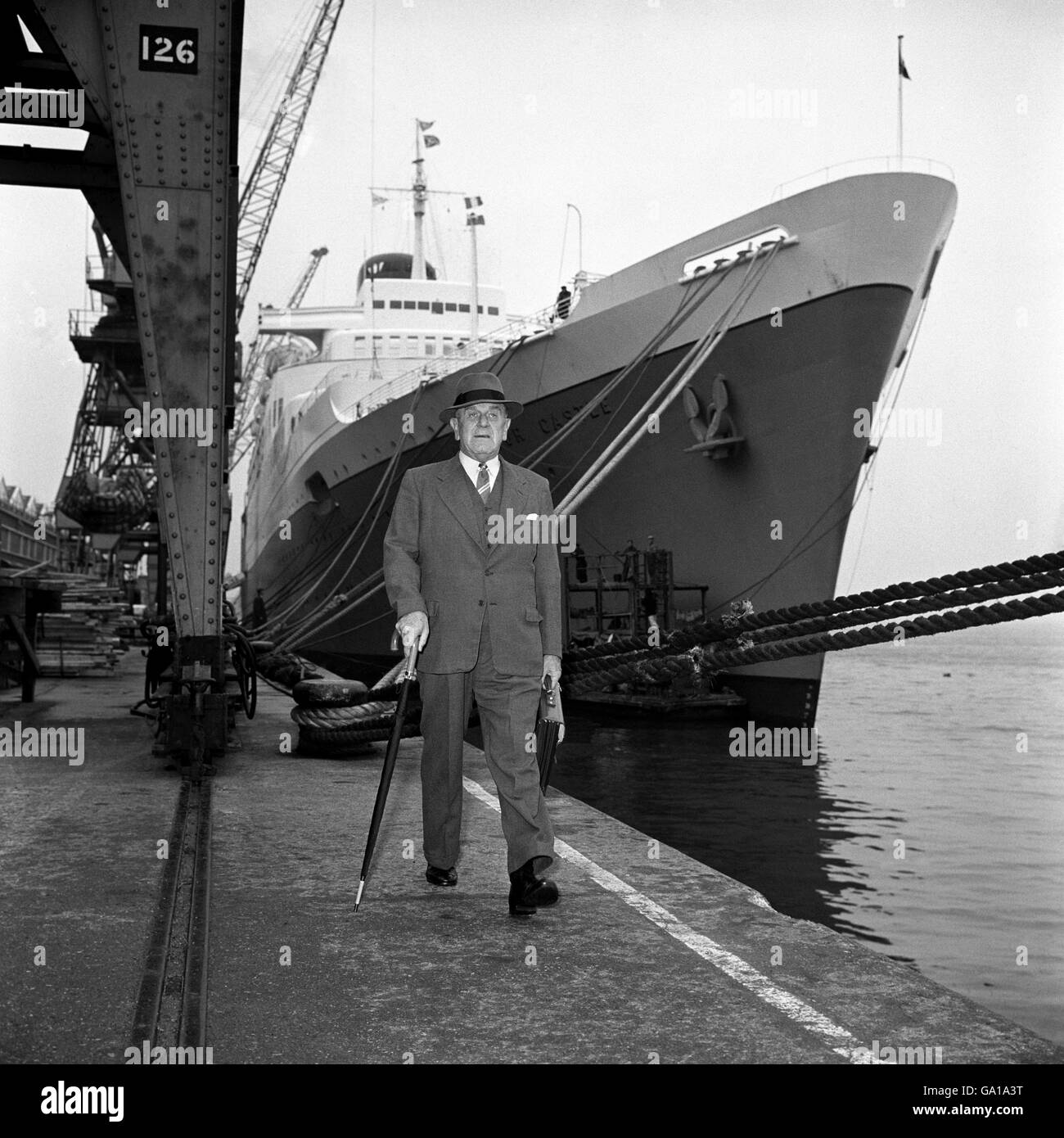 Captain George Mayhew walks from his last command, the Windsor Castle, at Southampton. He had brought her home after her maiden voyage to South Africa. Stock Photo