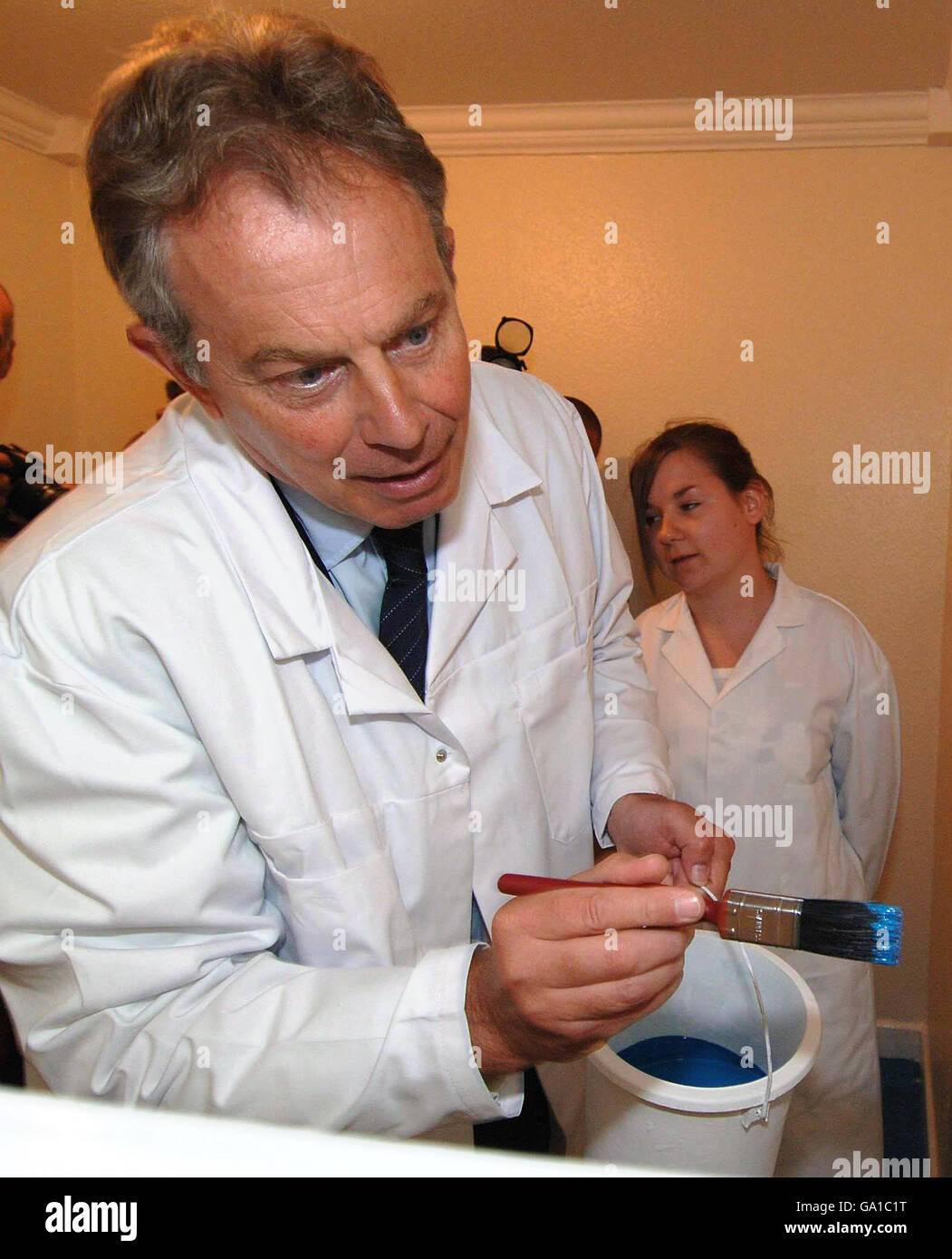 Britain's Prime Minister Tony Blair tries his hand at decorating during