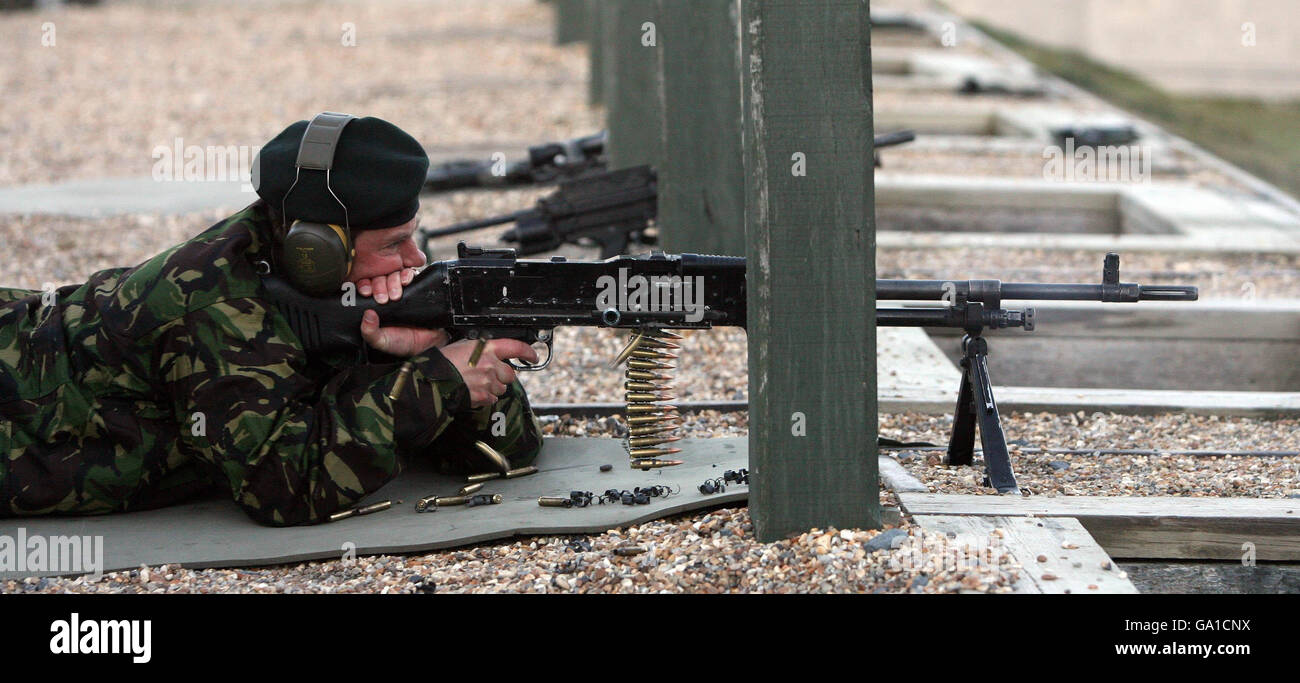 Spent cartridges fly as the Earl of Wessex fires a GPMG machine gun at a range in the British