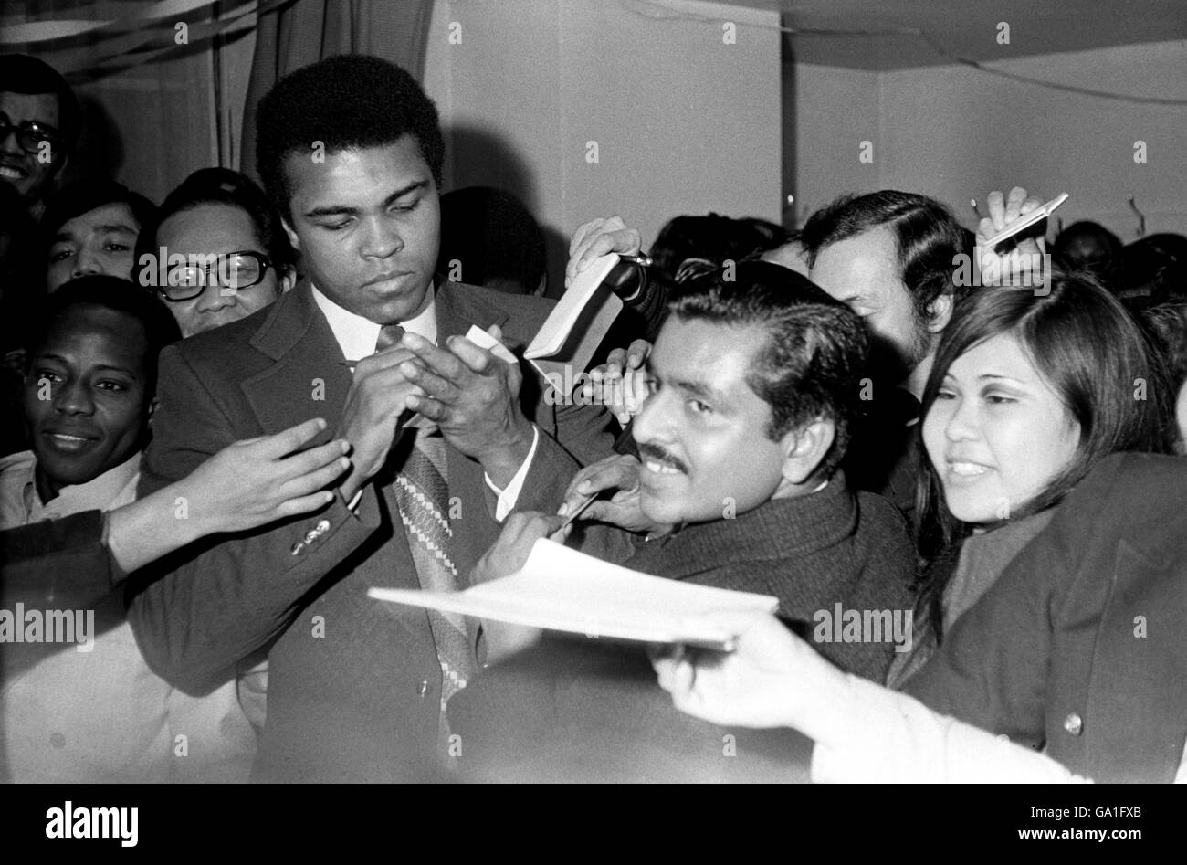 Cassius Clay signs autographs for adoring fans two days before his bout with Sonny Banks in New York Stock Photo