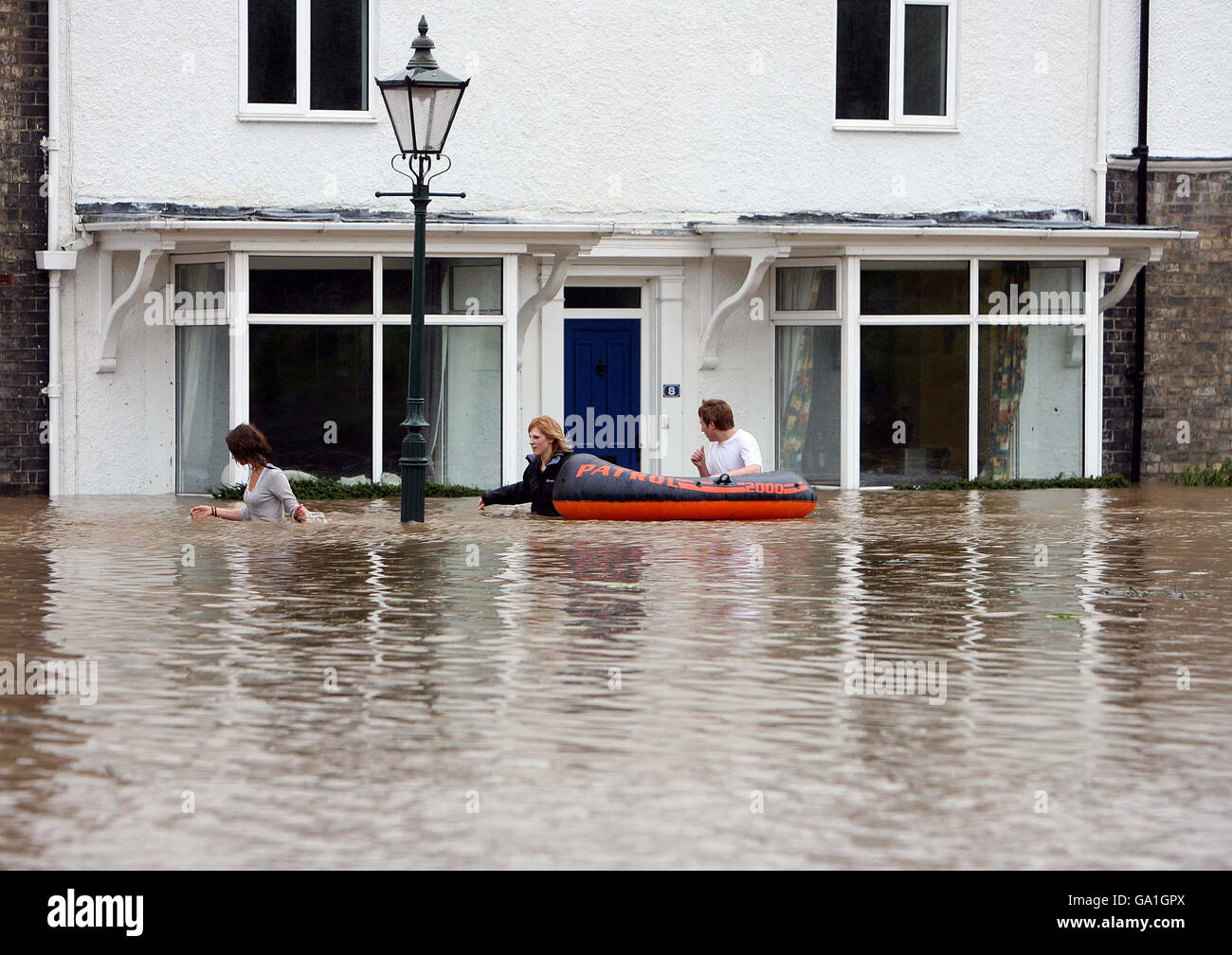 Flood warnings as torrential rain looms. Residents wade through water in Beverley, North East Yorkshire, after heavy rainfall caused flooding. Stock Photo