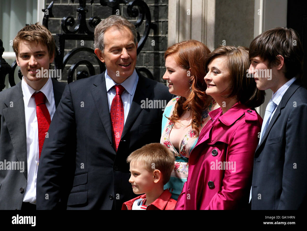Prime Minister Tony Blair accompanied by his family (left to right Euan, Kathryn, Cherie, Nicky. Front row: Leo pose on the steps of No.10 as leaves Downing Street, London. Stock Photo