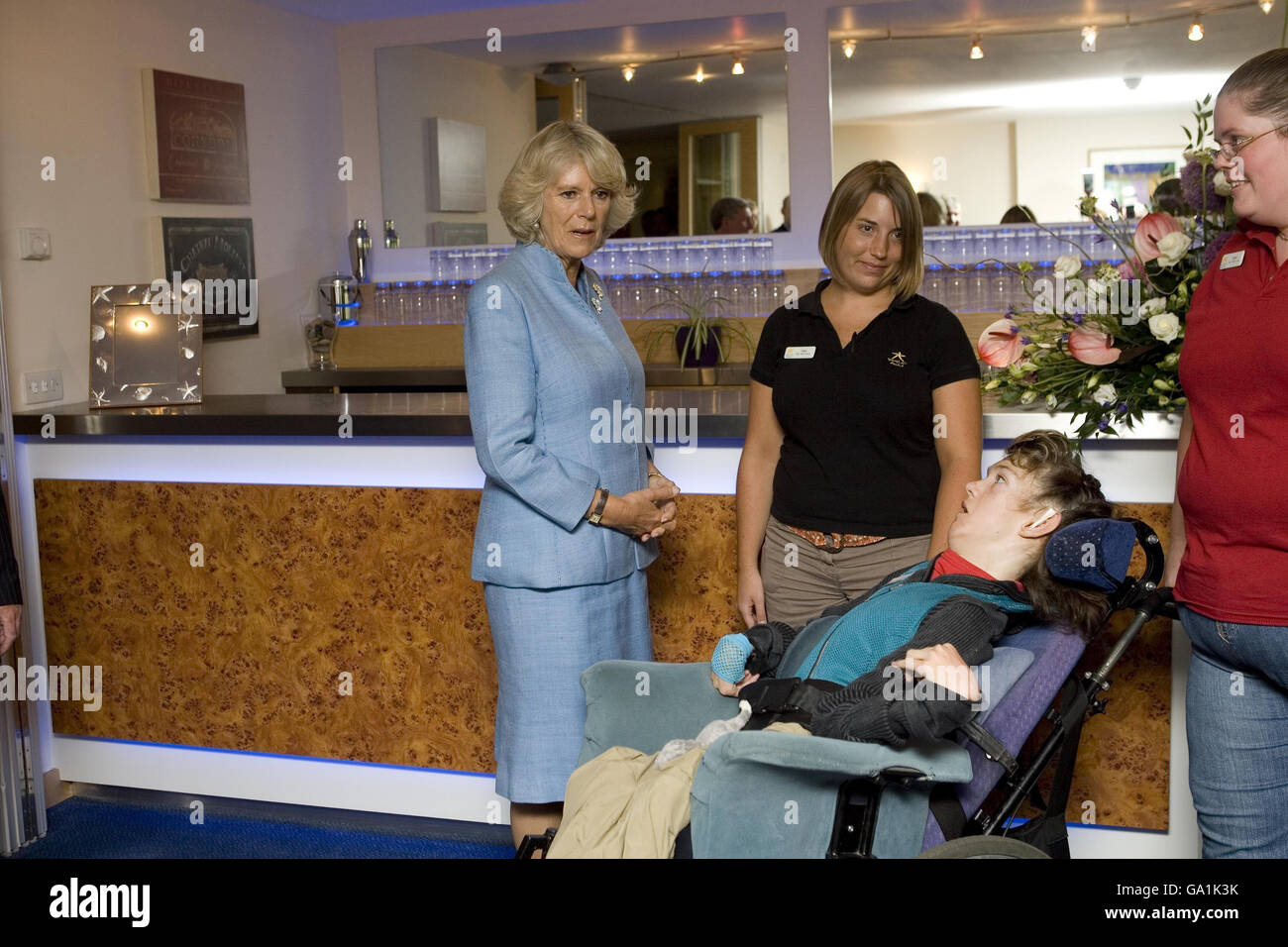 The Duchess of Cornwall meets guest Katie Gerrard (in the wheelchair) in the Bar of Douglas House during a visit to Helen and Douglas House, a hospice and respite care centre for children and young adults, in Oxford. Stock Photo