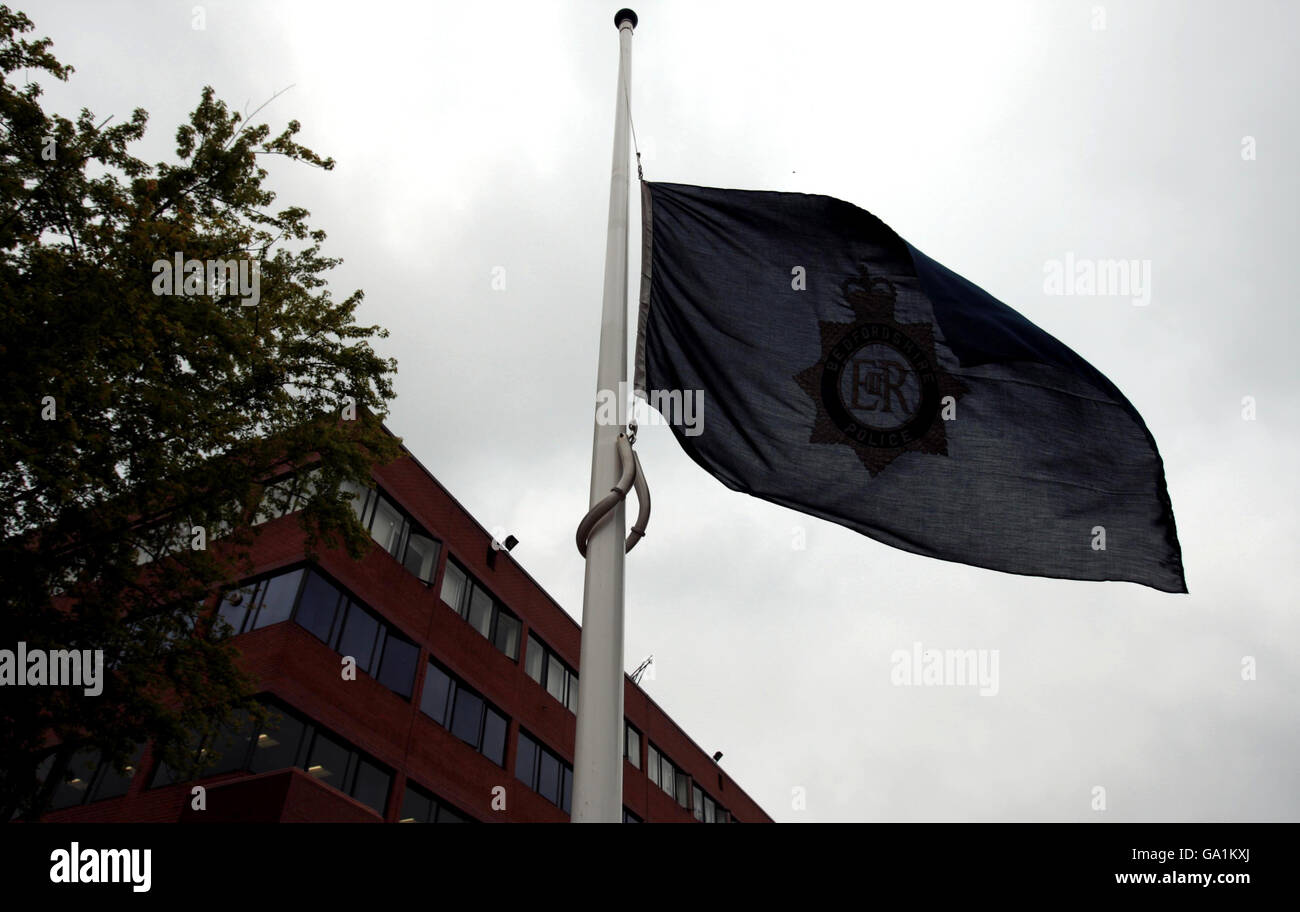 The constabulary flag flies at half mast outside Luton Police Station in Bedfordshire following the killing of Pc John Henry. Stock Photo