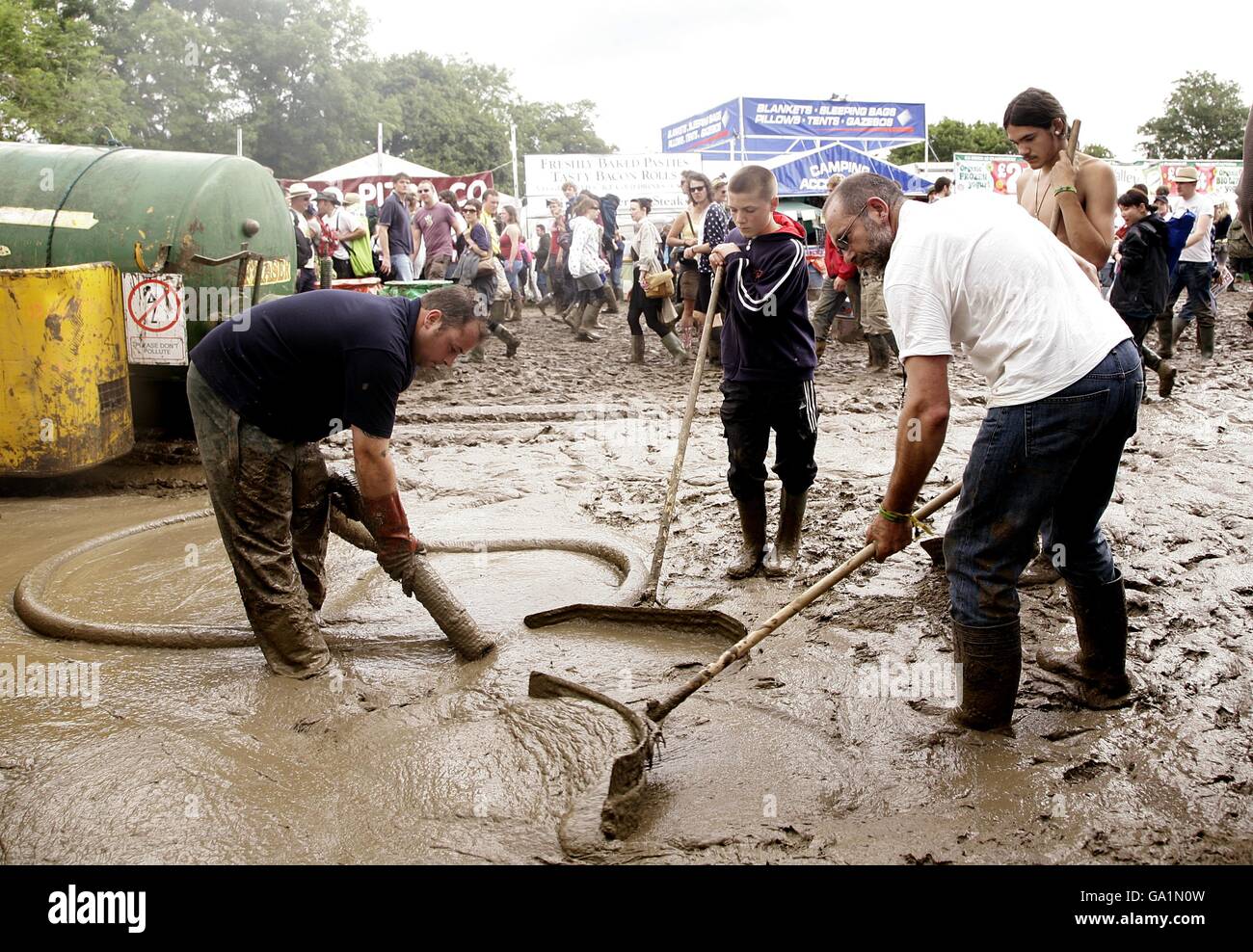 Festival staff try their best to dry out the ground at the 2007 Glastonbury Festival at Worthy Farm in Pilton, Somerset. Stock Photo