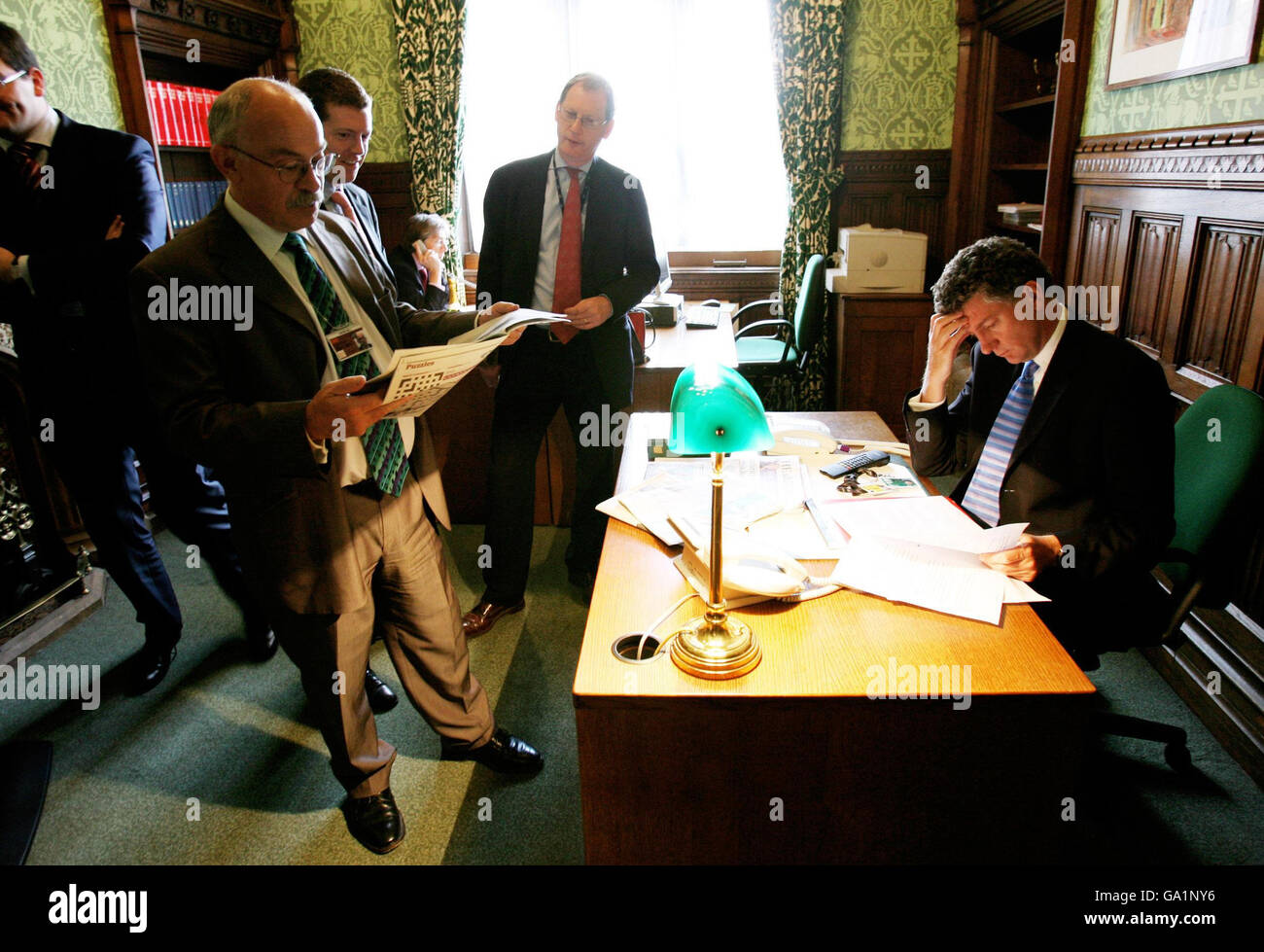 Previously unreleased photo of Prime Minister's staff from left, David Hill, Matthew Doyle, Tom Kelly and Jonathan Powell wait outside the PMs office as he prepares alone for PMQs in his office of the House of Commons minutes before entering the chamber on 13/6/2007. Stock Photo