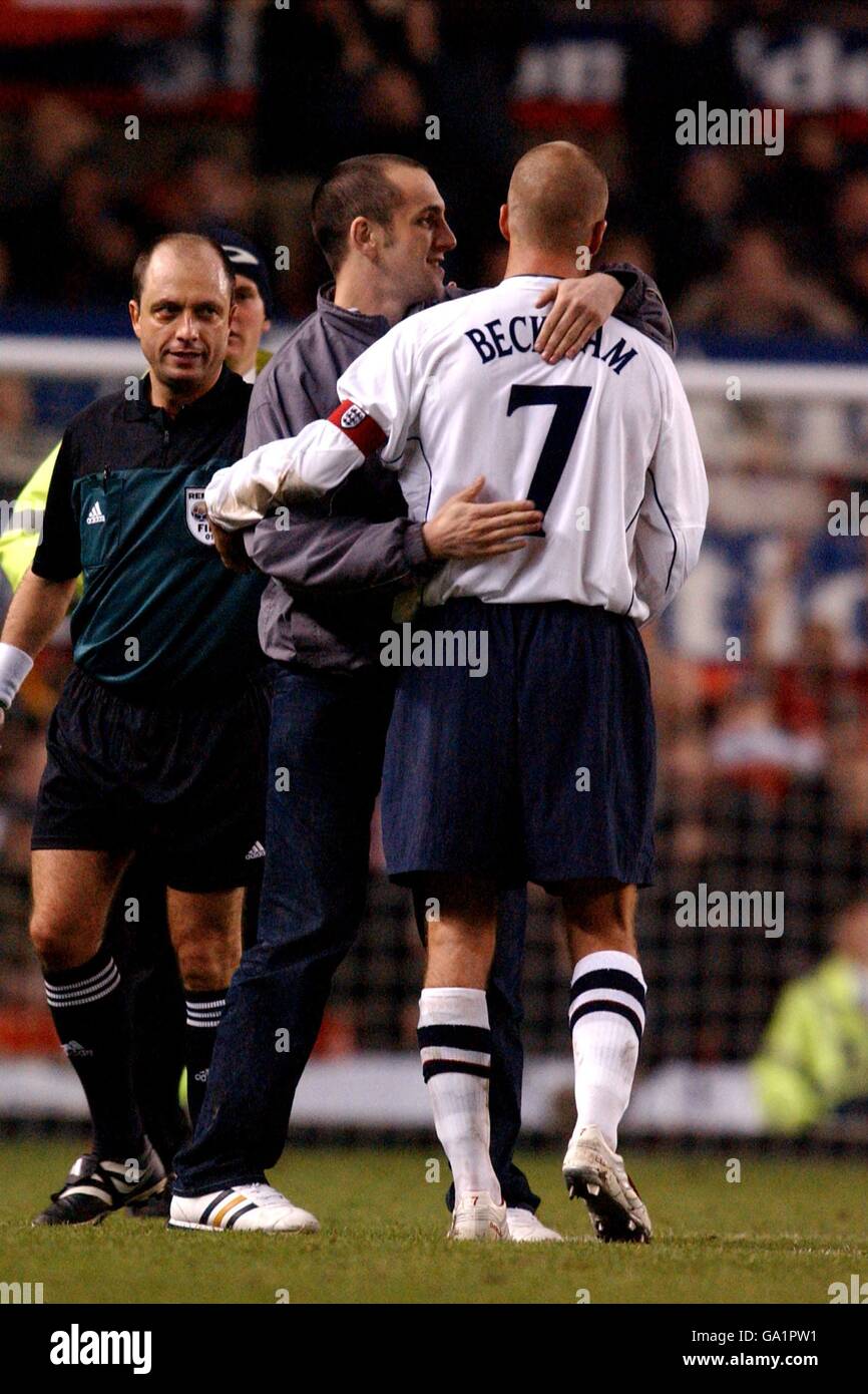 England's David Beckham is hugged by a fan during the game against ...