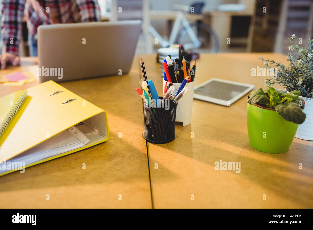 Pen holder with pens and file on table Stock Photo Alamy