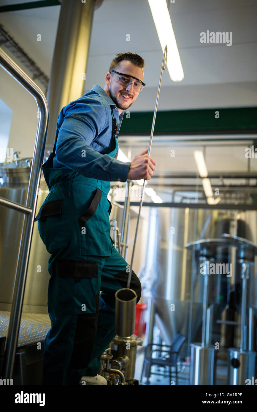 Happy Brewer holding working equipment Stock Photo