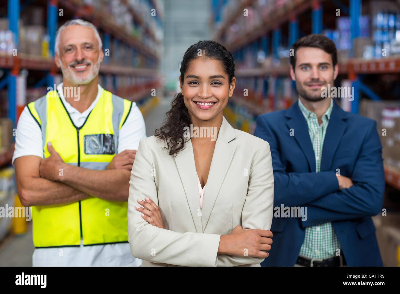 Happy team is smiling and posing with crossed arms Stock Photo - Alamy