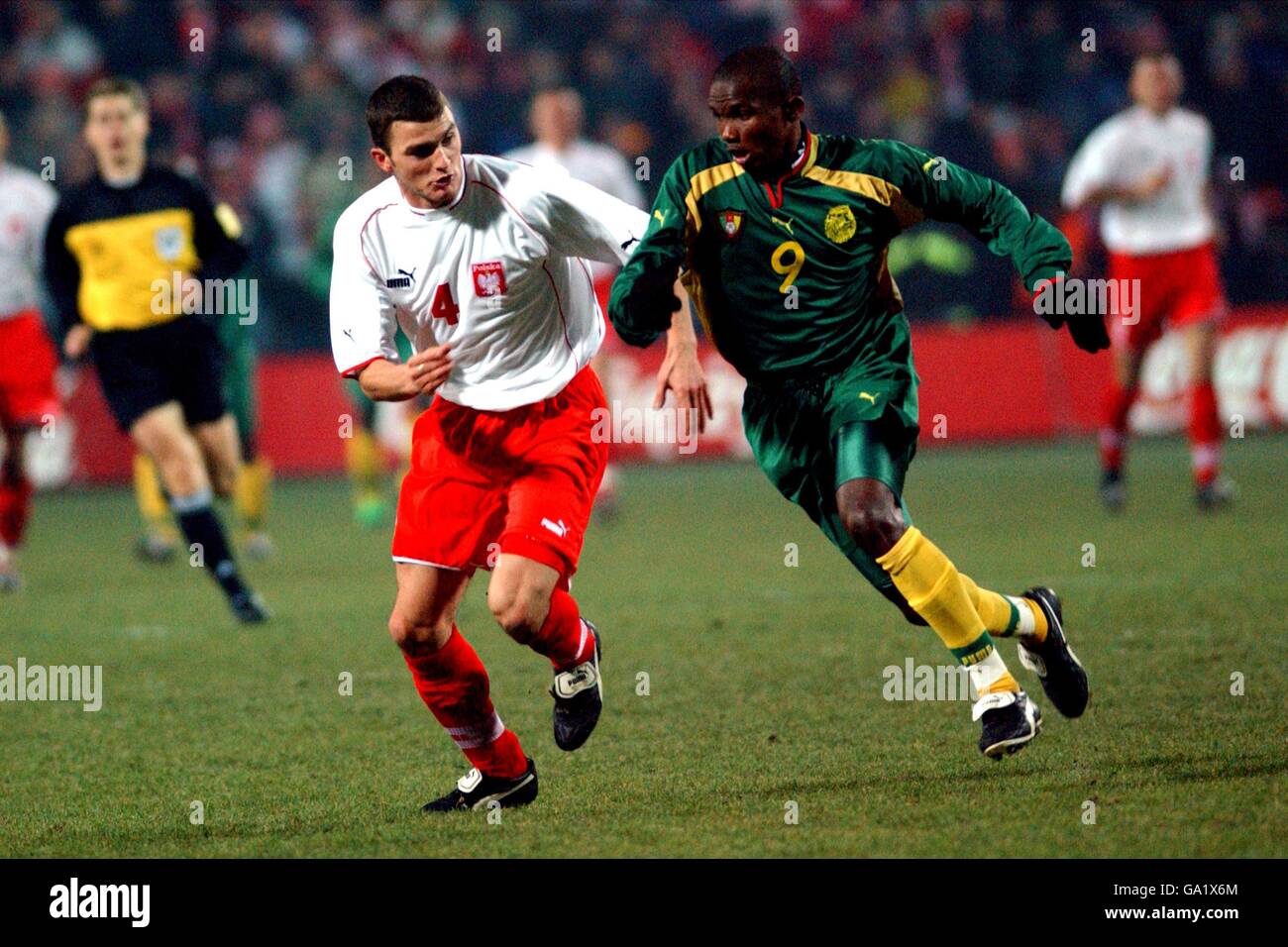 Cameroon's Samuel Eto'o (r) tries to get past Poland's Michal Zewlakow (l) Stock Photo