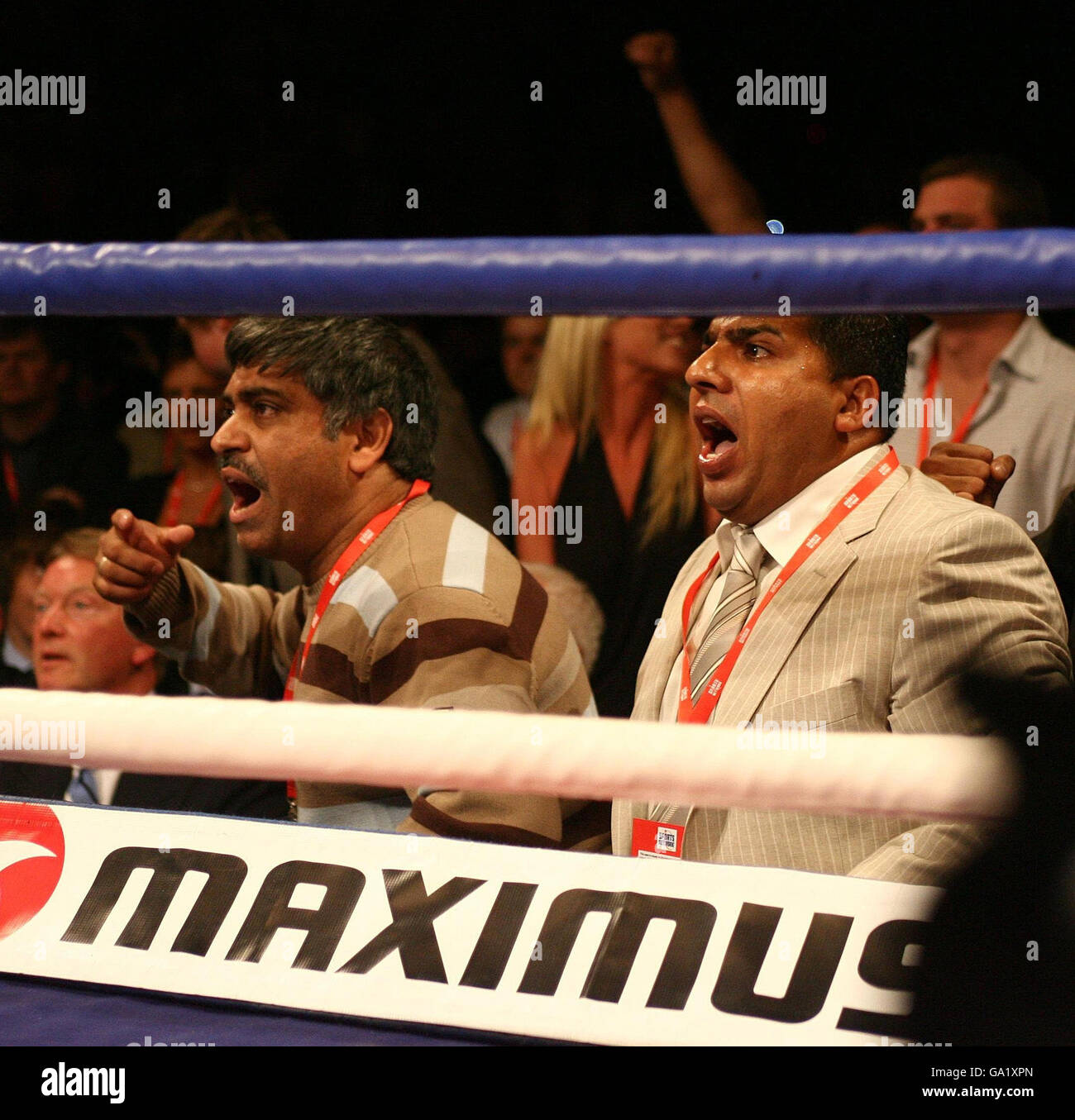 Amir Khan's father Shah Khan and manager Asif Ali shout support during the Commonwealth Lightweight Title fight at the O2 Arena, London. Stock Photo