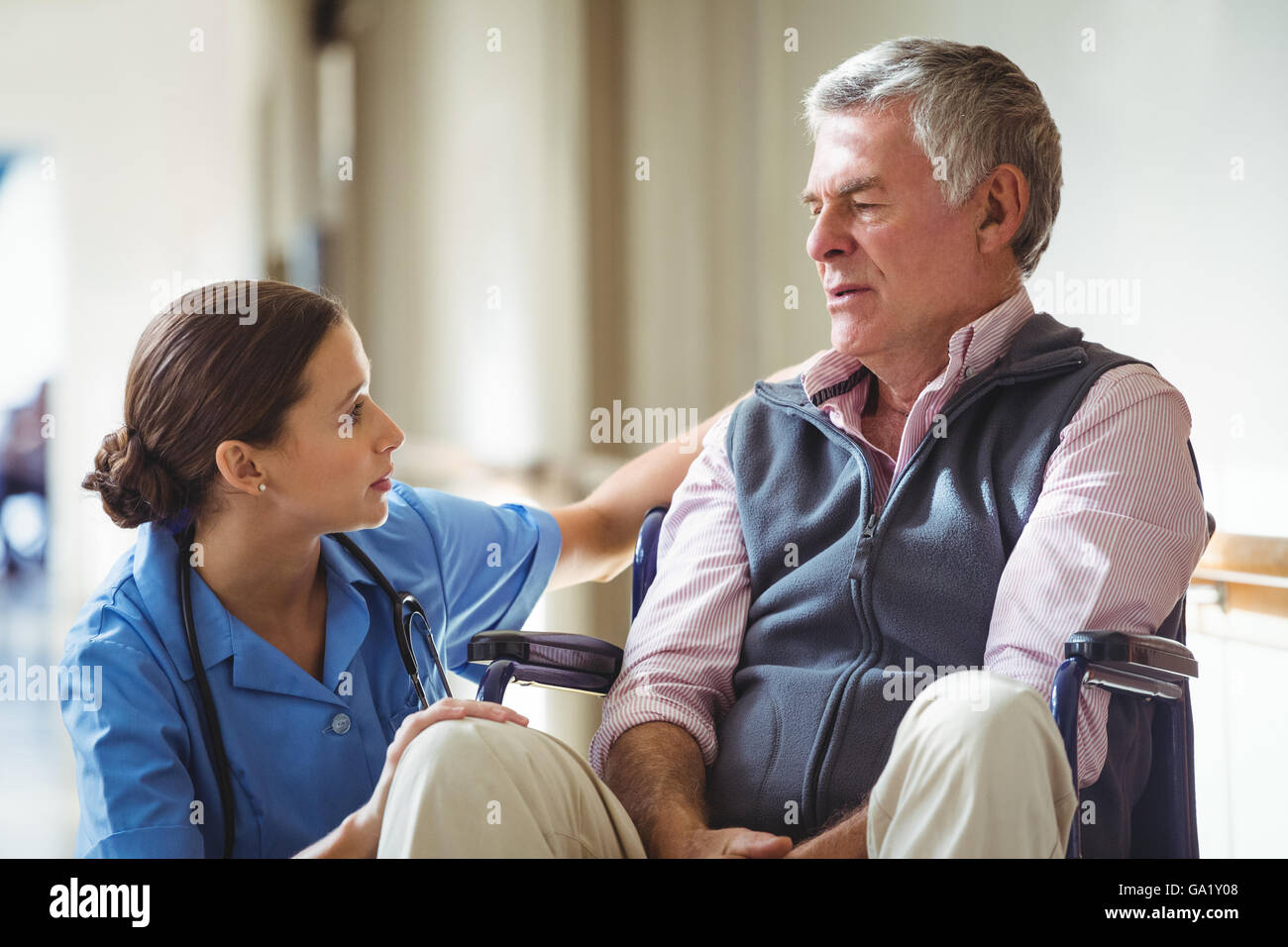 Nurse taking care of sad senior man Stock Photo