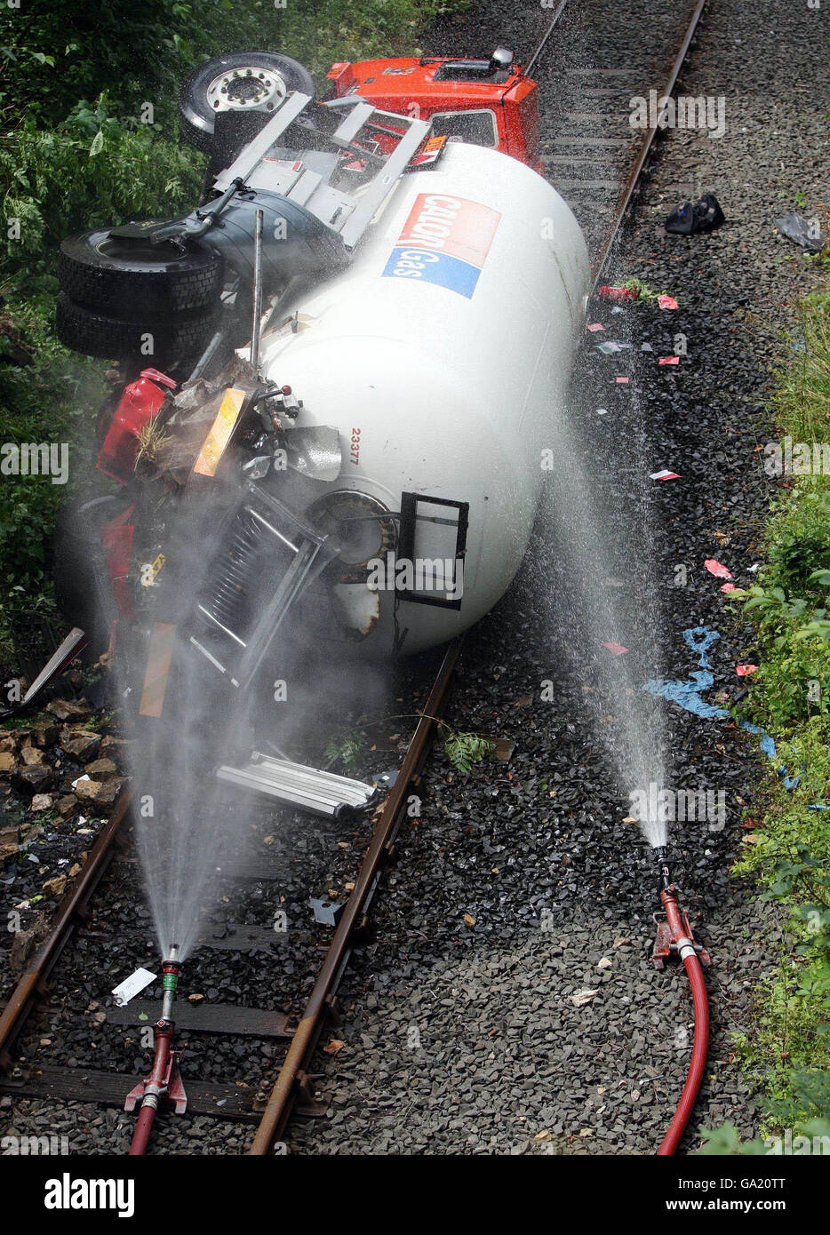 Gas tanker accident. An overturned gas tanker lies on a railway line in