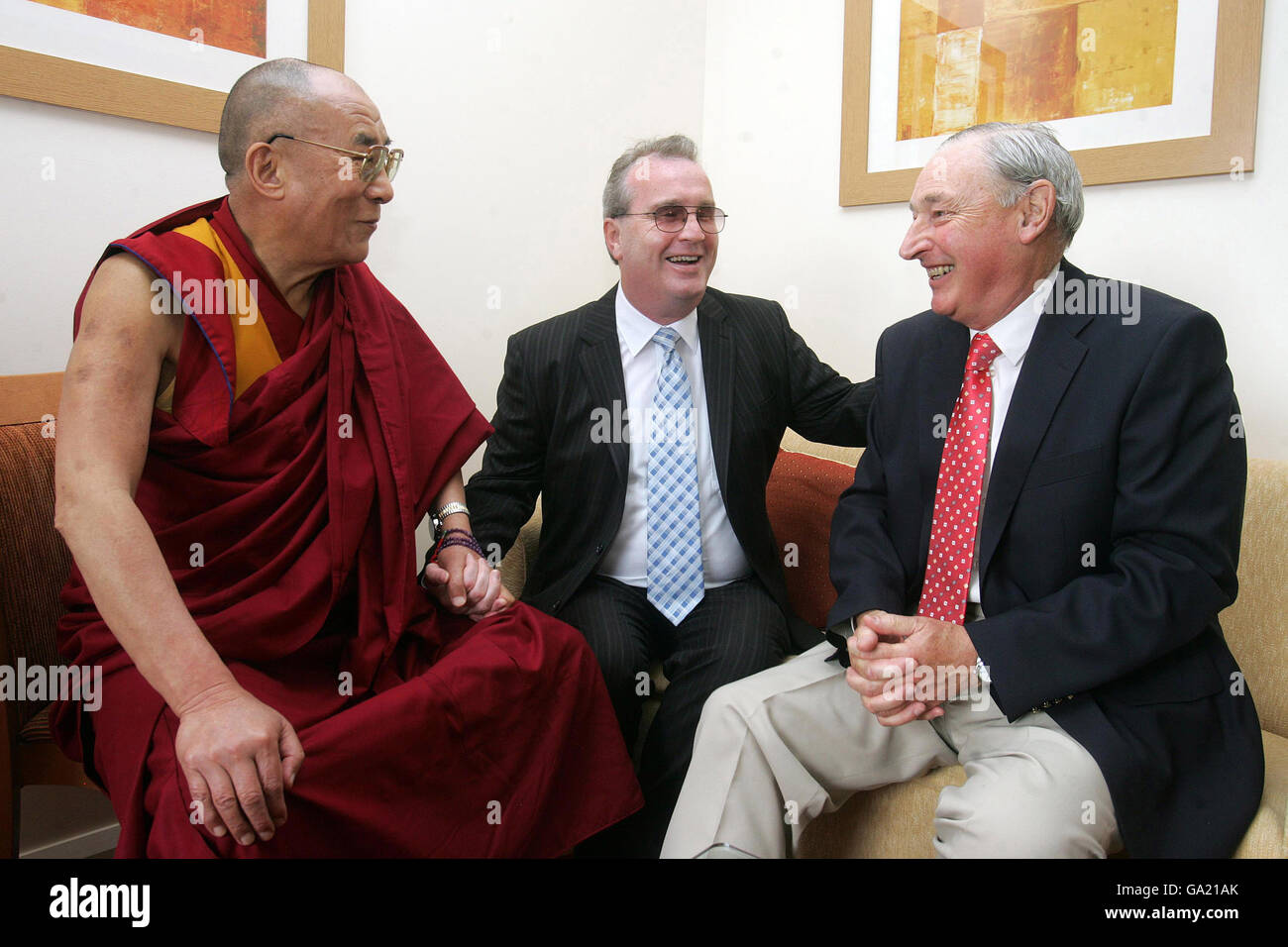 His Holiness, the 14th Dalai Lama of Tibet pictured with Richard Moore, Director of Children in Crossfire (centre) and Charles Inness (right), the soldier who fired the plastic bullet that blinded Richard when he was a 10 years old boy. Stock Photo