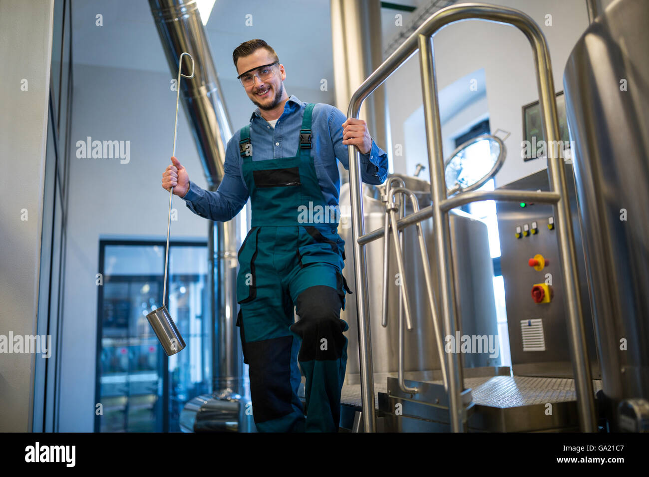 Brewer holding working equipment at brewery Stock Photo