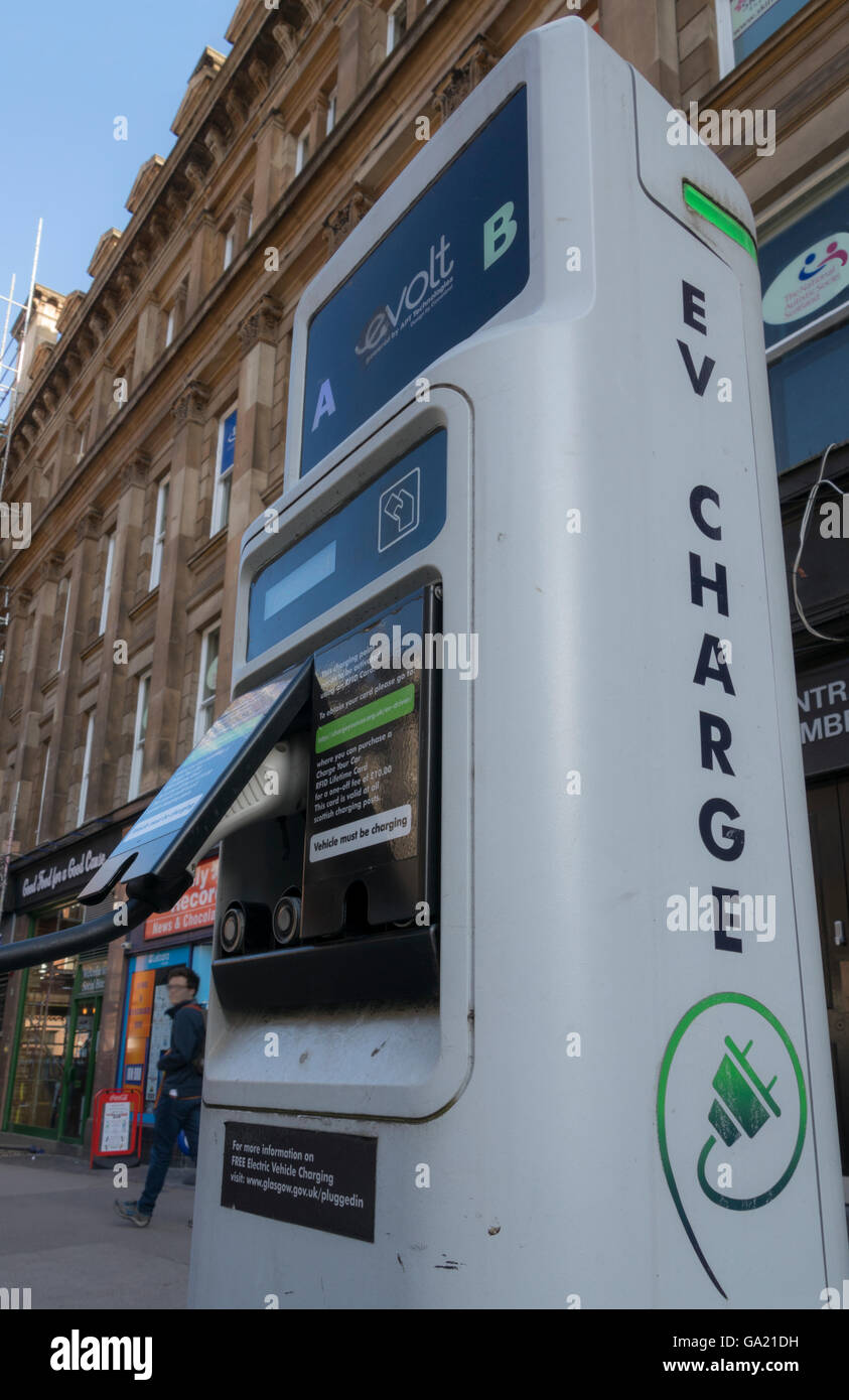 Electric vehicle parked at city centre street charging station, Glasgow